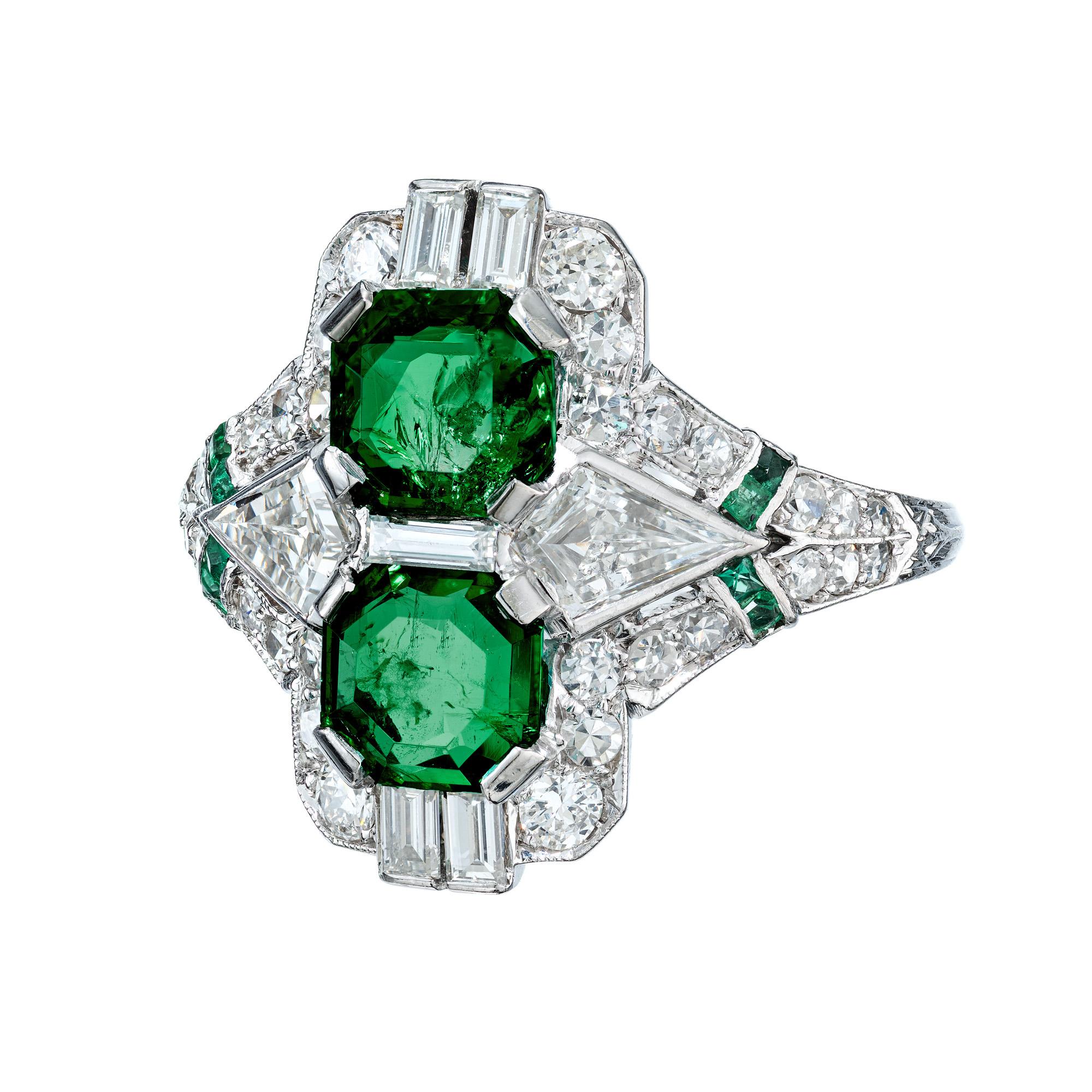 Original circa 1930s bright green emeralds and diamond cocktail ring. The ring has two larger step-cut emeralds with natural color and low level clarity enhancement and a total weight of approximately 1.20cts. They are accompanied by 2 beautiful