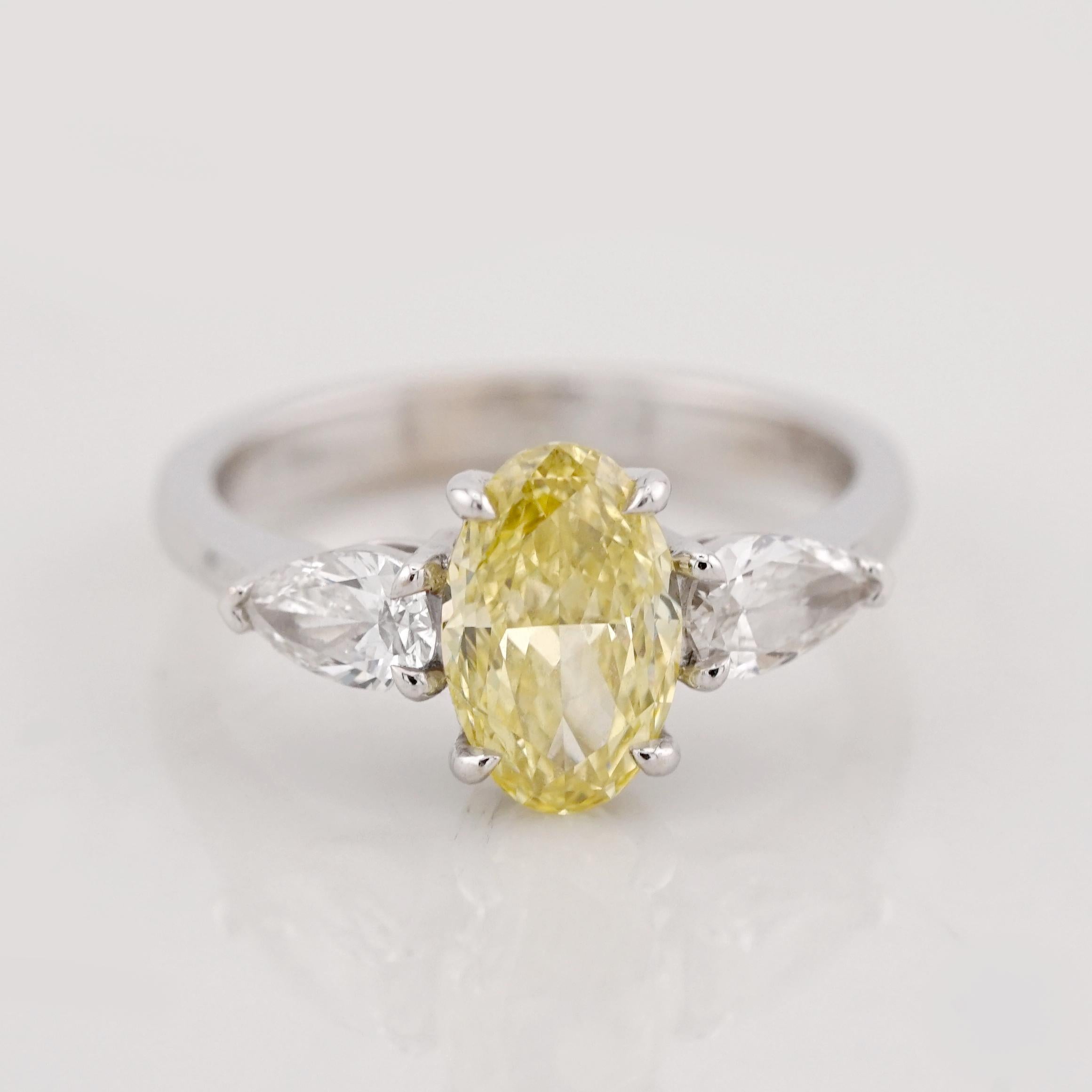 This exquisite ring showcases a stunning 1.22-carat Fancy Intense Yellow oval-cut diamond, certified by GIA for its exceptional color (Natural origin, Even distribution) and quality (SI2 clarity). 

The diamond's vibrant hue and brilliance make it a