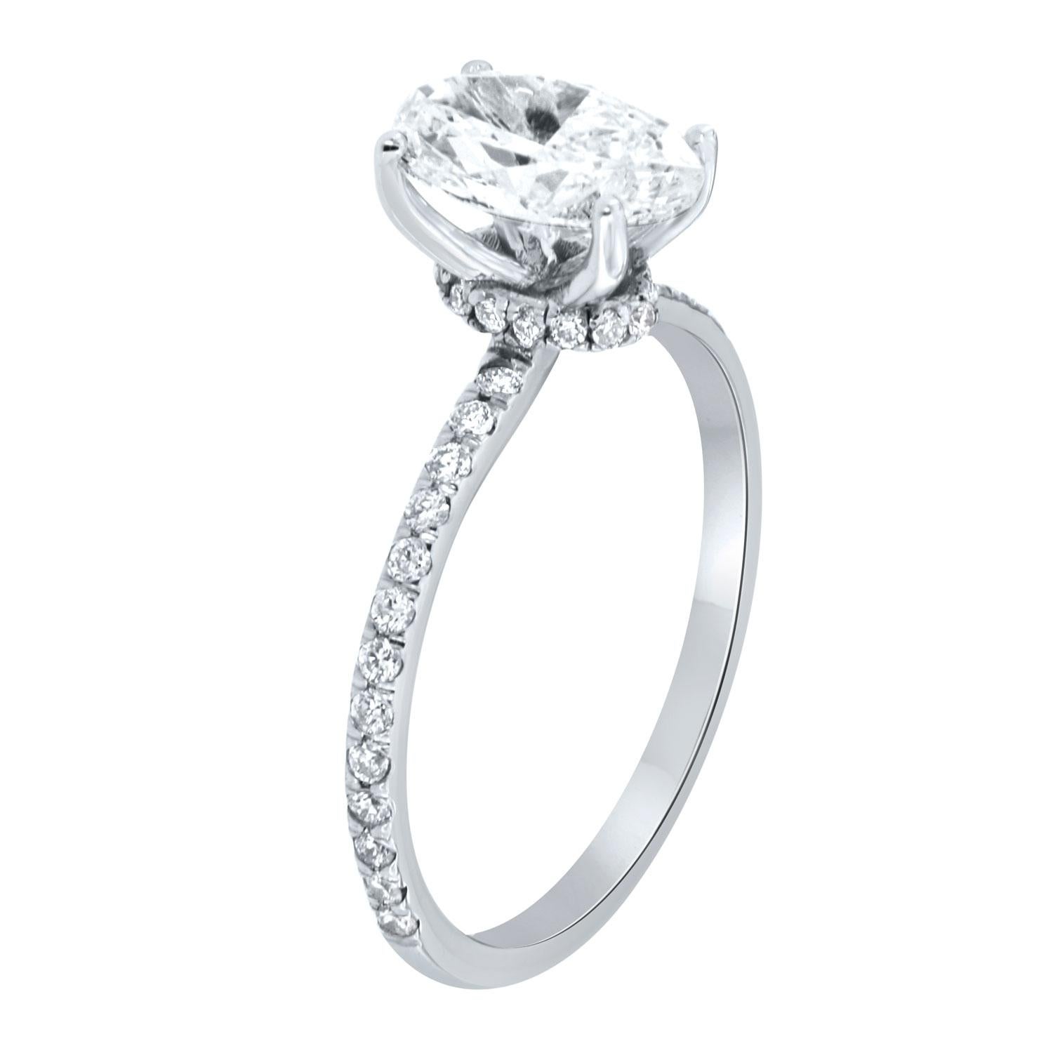 This stunning engagement ring features a 1.20 Carat Oval shape diaomnd GIA certificate 6381721732. This perfectly shaped Oval is G in color and VVS1 in clarity. A row of brilliant round diamonds encircles a hidden halo underneath delicate prongs.