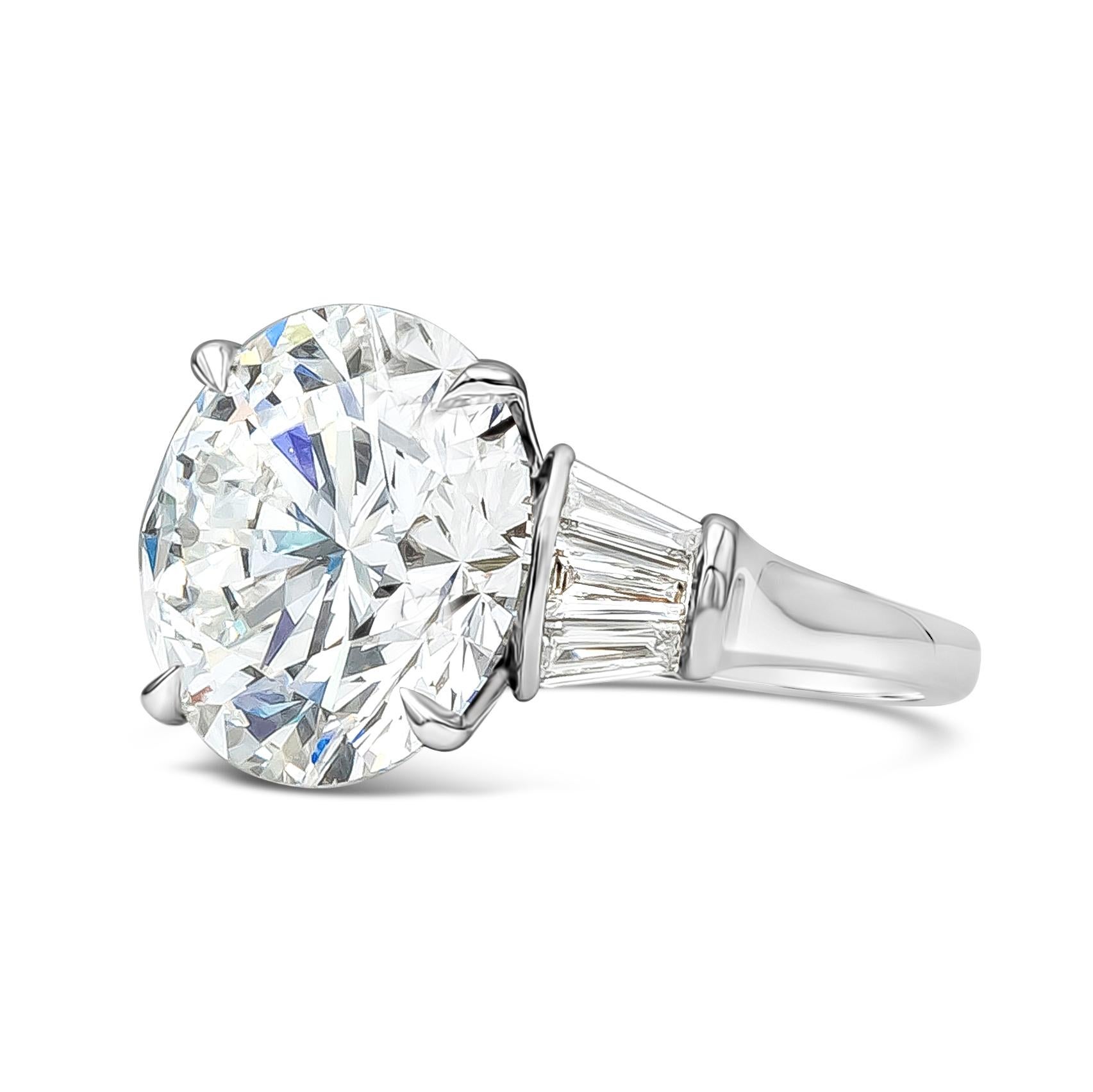 This gorgeous important engagement ring features a GIA Certified 12.03 carat brilliant round shape diamond, F in Color and VS1 in Clarity, flanked by 3 tapered baguettes on each side weighing 0.98 carats total, F Color and VS in Clarity. Finely Made