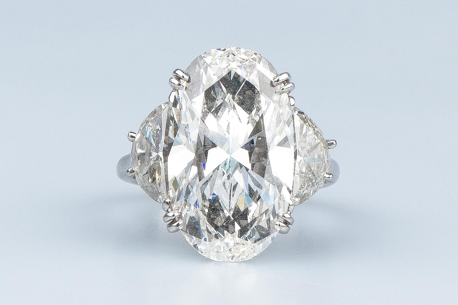 18 carat white gold elegant ring designed with 1 oval cut center natural diamond weighing 12.09 carat realised and created by William Goldberg, an American diamond dealer and the founder of the William Goldberg Diamond Corporation. 

Quality of the