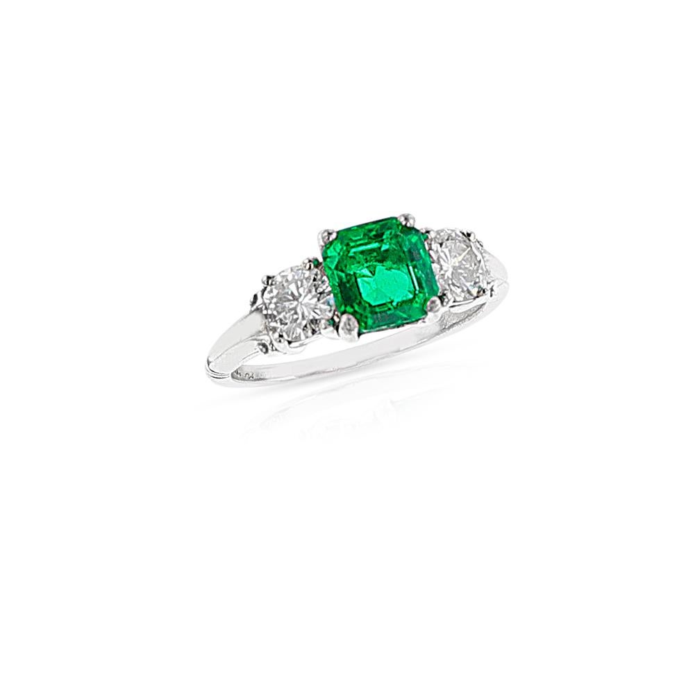 A GIA certified 1.21 ct. Octagonal Step-Cut Colombian Emerald Ring with Two Diamonds. Platinum. Total Weight: 4.20 grams, Ring size US 5.25.