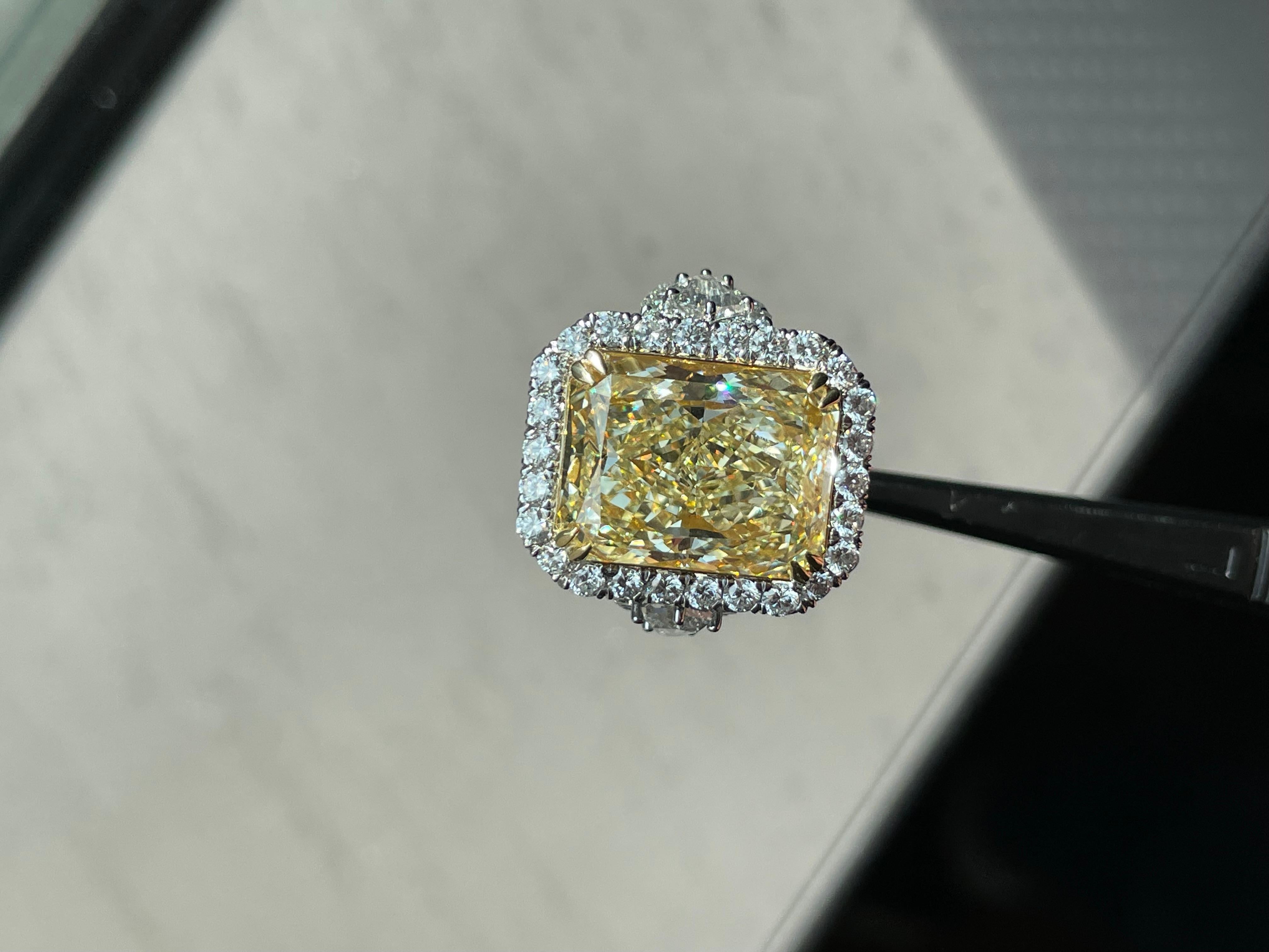 Extraordinary 12.12 Carat Fancy Light Yellow Radiant Cut Engagement Ring 

Setting:
Platinum/18K

Center Stone: Fancy Light Yellow
Carat Weight: 12.12
Clarity: VS1

Side Stones: Shield Cut Diamonds & Round Diamonds
Color: F-G
Clarity: VS
Cut: