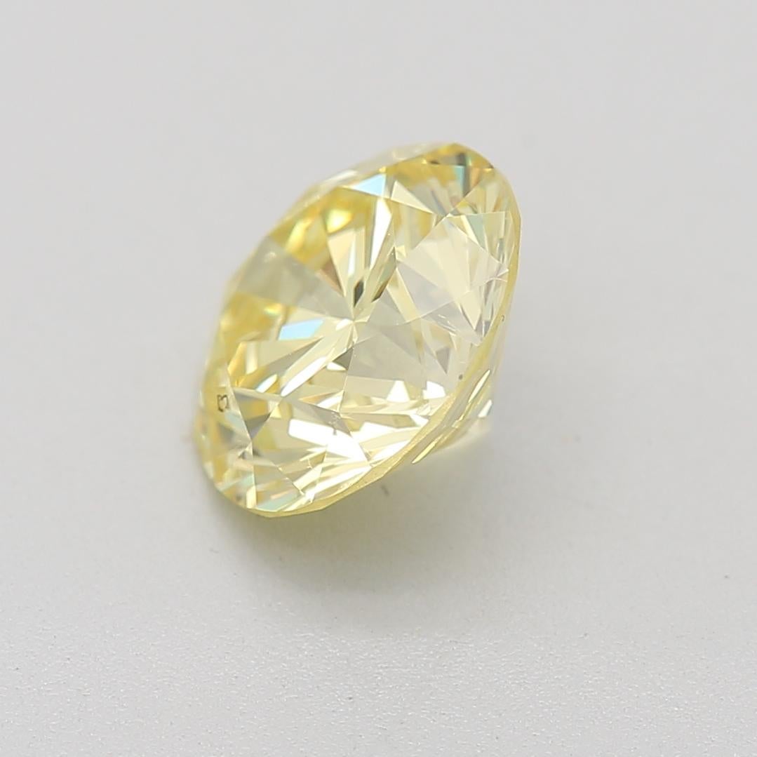 Taille ronde Diamant jaune fantaisie de 1.22 carats certifié par le GIA en vente