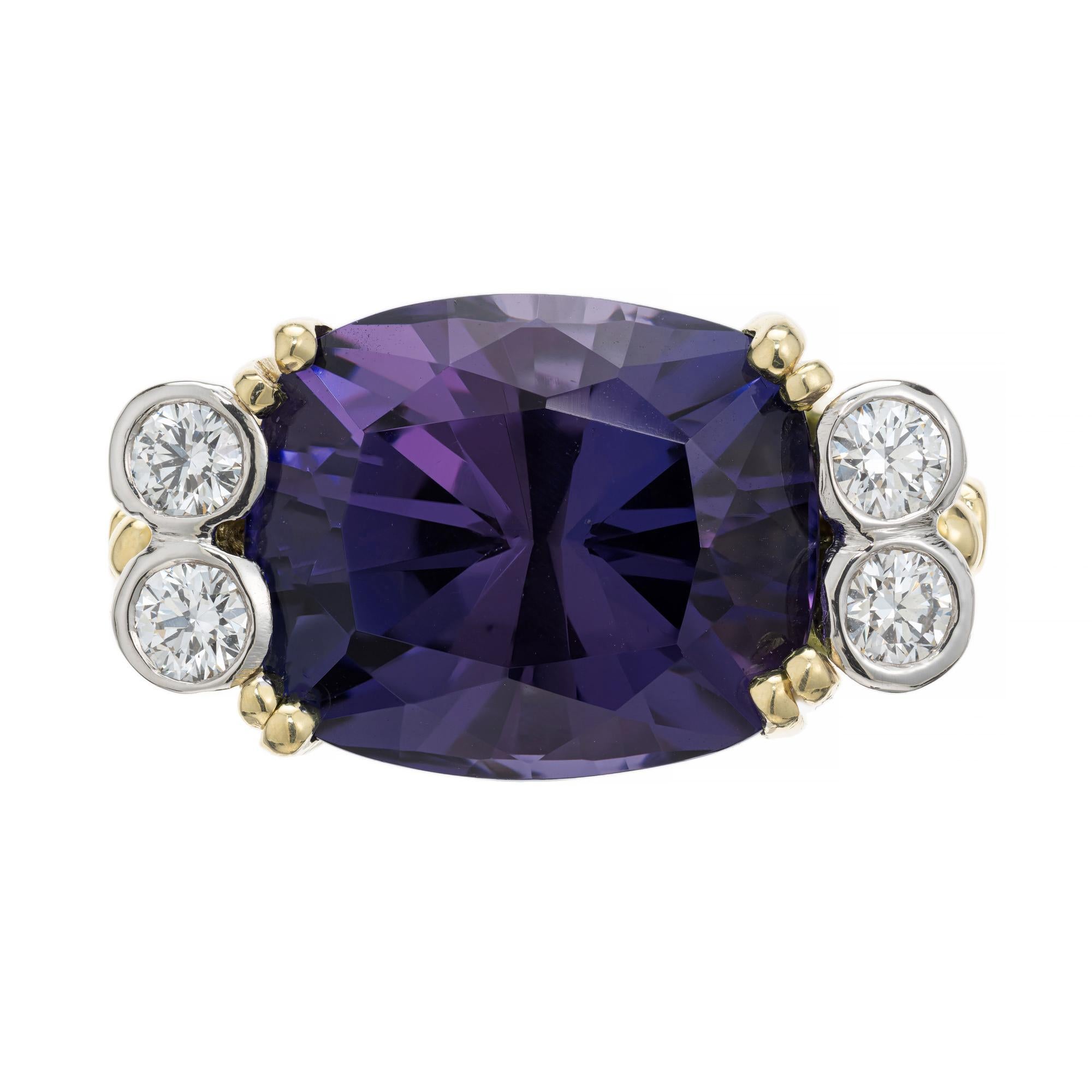 Tanzanite and diamond cocktail ring. GIA certified oval 12.30ct Tanzanite center stone, mounted in 18k white and yellow gold setting. This stunning tanzanite is violet and blue in color and set horizontal instead of the traditional vertical styling.