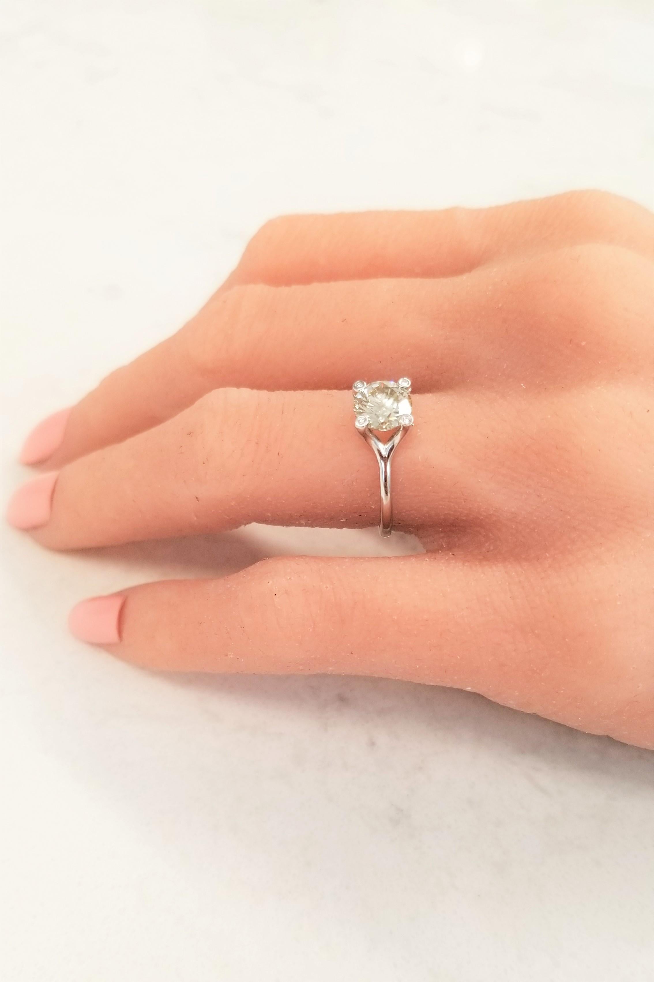 There is something so special about a high-quality sparkling diamond set in 18k white gold. The versatility is through the roof on this one! This solitaire features a sparkling 1.24 Carat fancy light brownish-greenish yellow diamond center. Worn