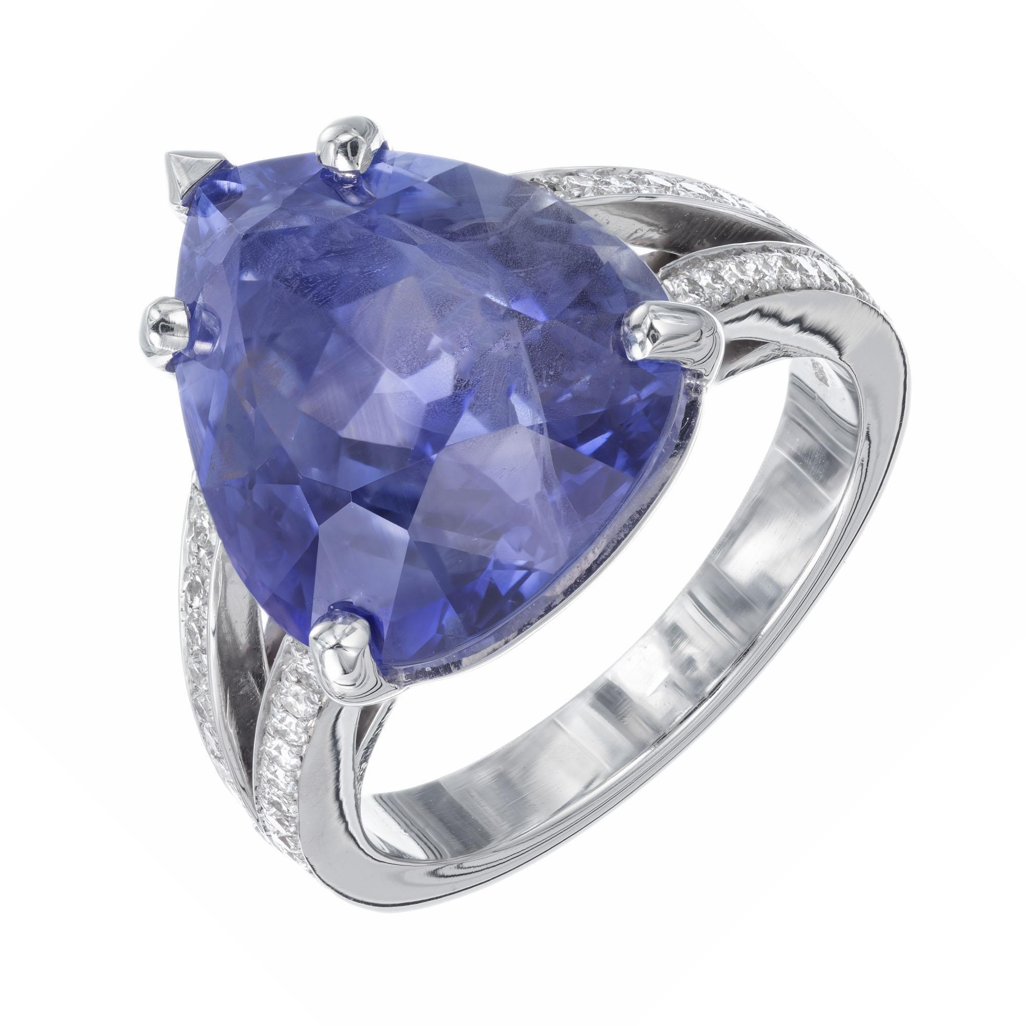 Sapphire and diamond engagement ring. Pear shaped sapphire center stone set in a platinum setting with 48 round ideal cut diamonds.  There are natural veil type flaws and feathers that partially separate the color zones. 

1 pear shaped blue