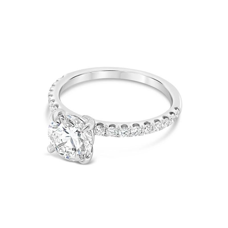 An 18 karat white gold engagement ring featuring a 1.25 carat round brilliant cut diamond, G SI2, accented by 0.34ctw diamonds that go halfway down the band. It is currently a size 6.5 but can be resized upon request.
Measurements: 7.00 - 7.04 x
