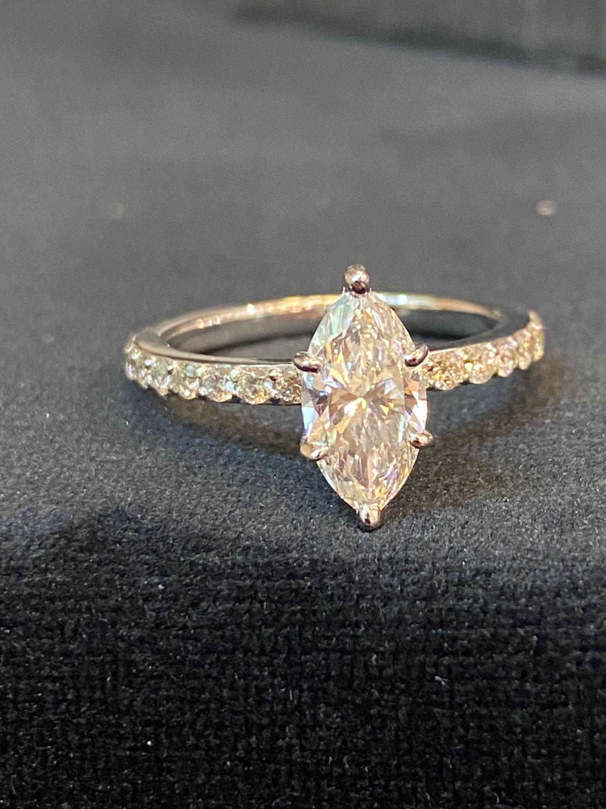 So chic and minimal design for this solitaire in 18k gold with a pear cut diamond 1,25 carats, G/SI1 , GIA certified , and round brilliant cut diamonds 0,65 ct. 
Handmade by artisan goldsmith .
Excellent manufacture and quality.
Complete with GIA