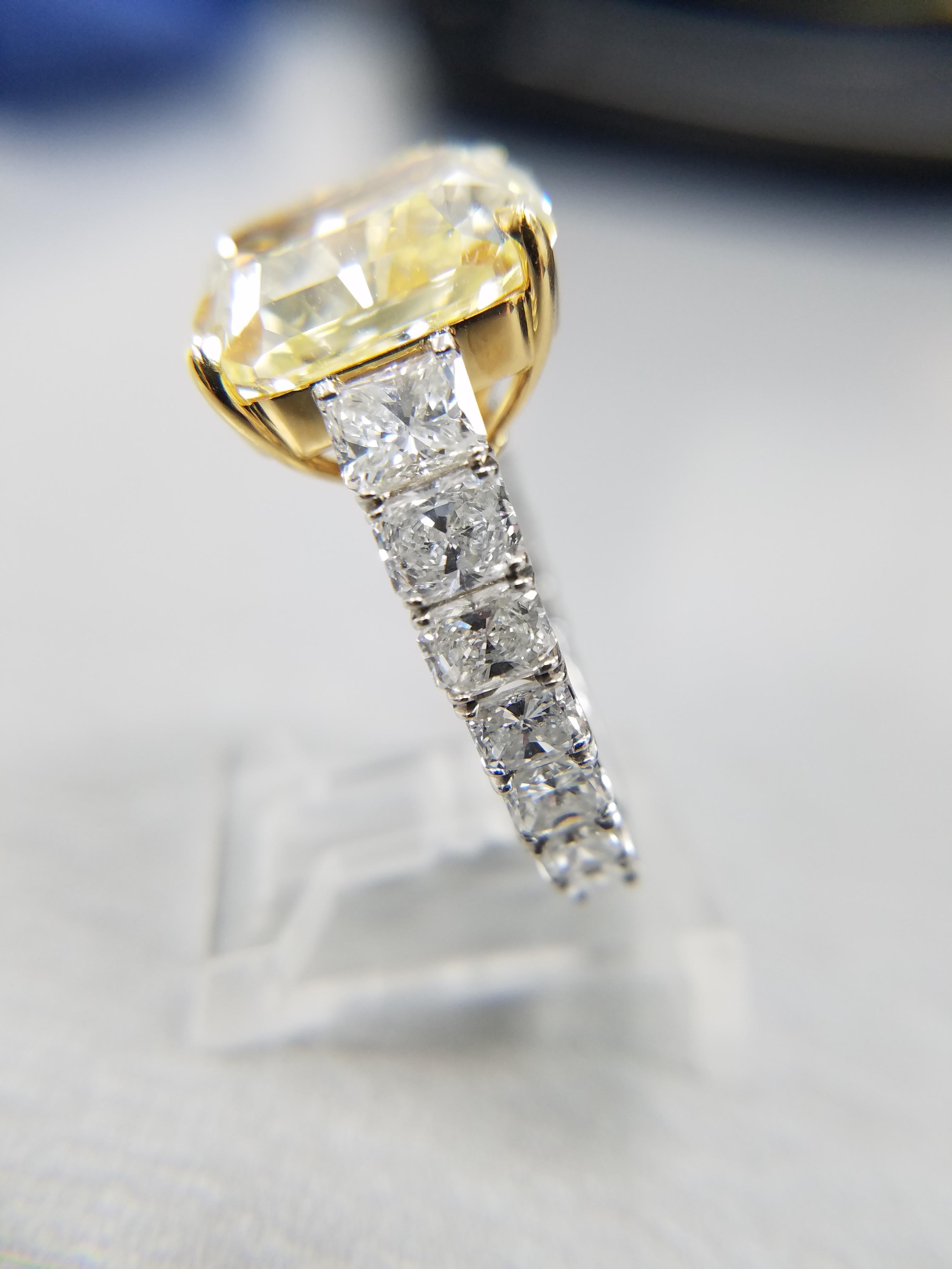 GIA Certified 12.50 ct Natural Fancy Yellow Radiant Diamond Ring. The setting is Platinum and Yellow Gold with 14 Radiant cut diamonds on the sides totaling 4.21 carats. This ring is one of our original Louis Newman & Co creations designed by
