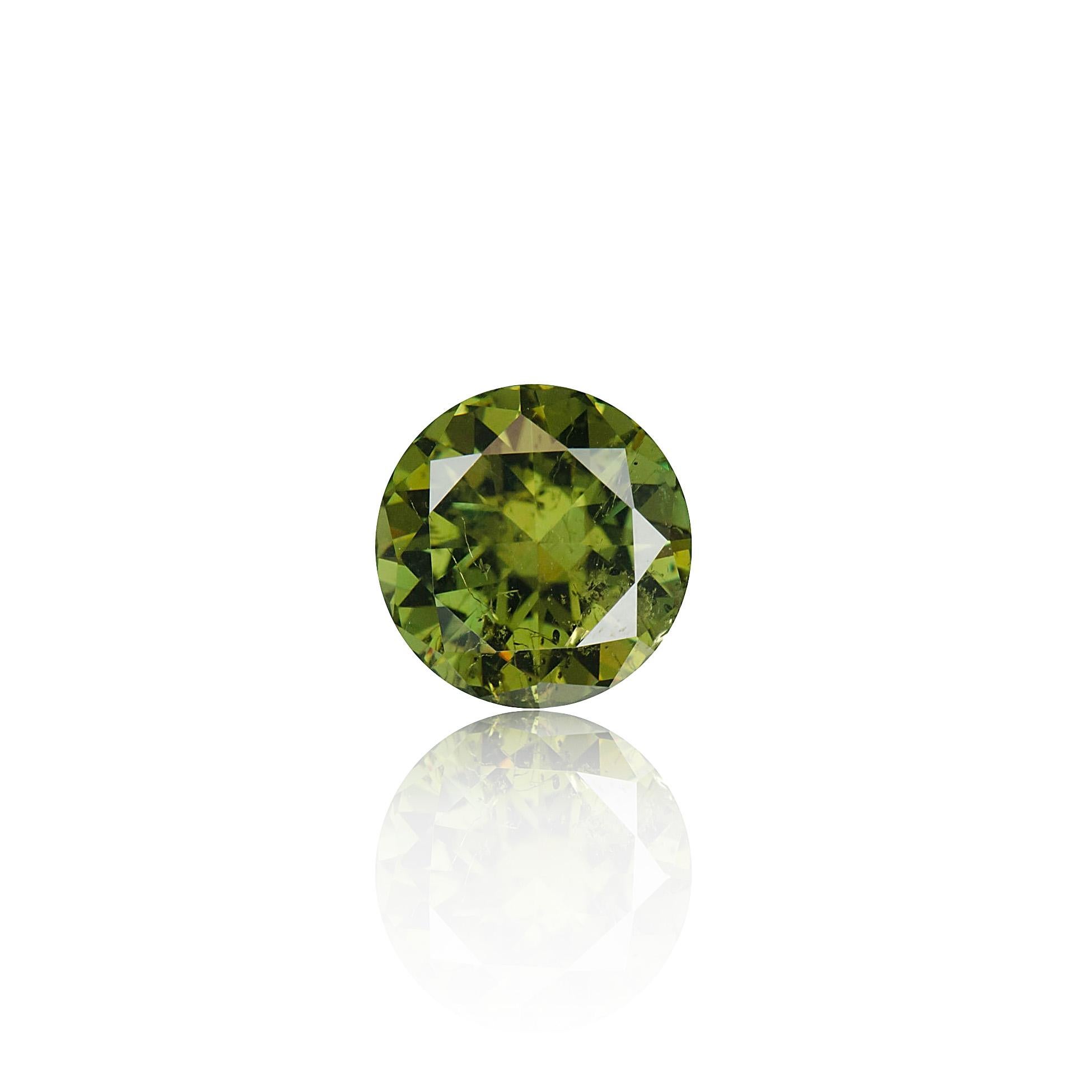 This tremendous over 12.50 carat green-brown round cut garnet var. demantoid from Madagascar displays a few horsetail inclusions. Commonly found in this rare species of garnet, the inclusions far from detract from the demantoid's intense sparkle and