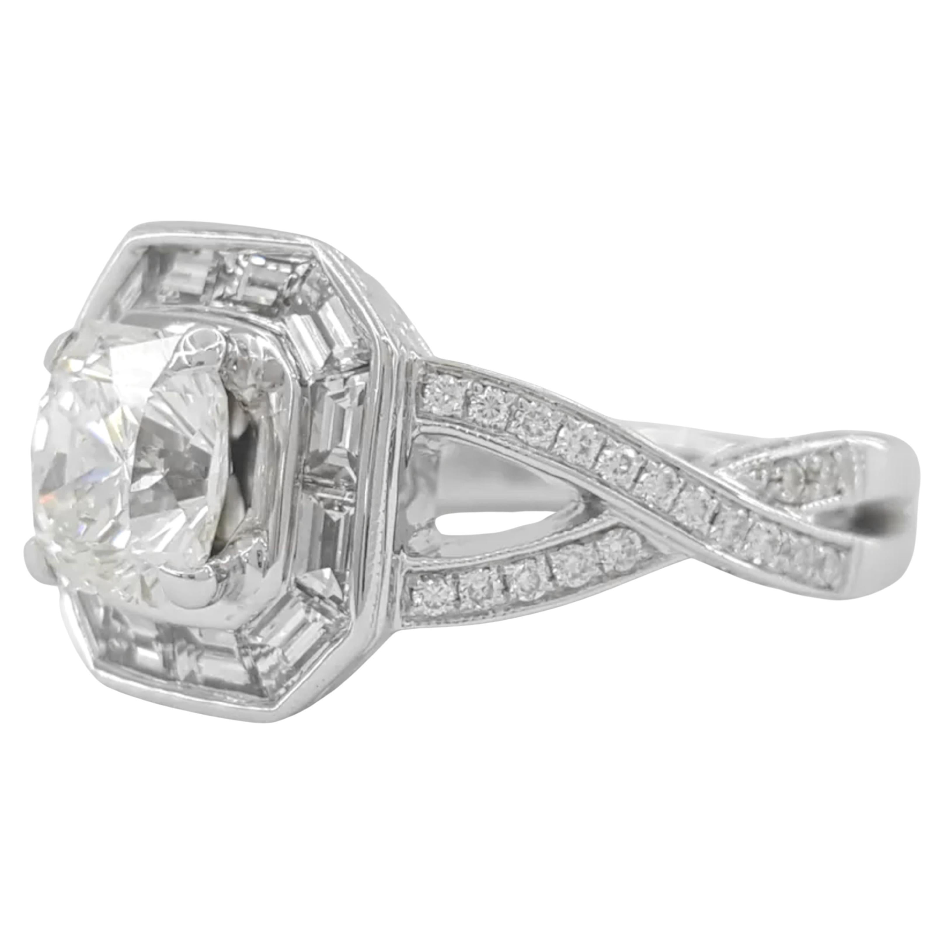 2.17 ct Total Weight 18K White Gold Flanders Ideal Cut Diamond Halo Engagement Ring is an exquisite piece that showcases a stunning array of diamonds. The ring weighs 7.3 grams and is a size 6.

At its center, the ring features a Flanders / Elara