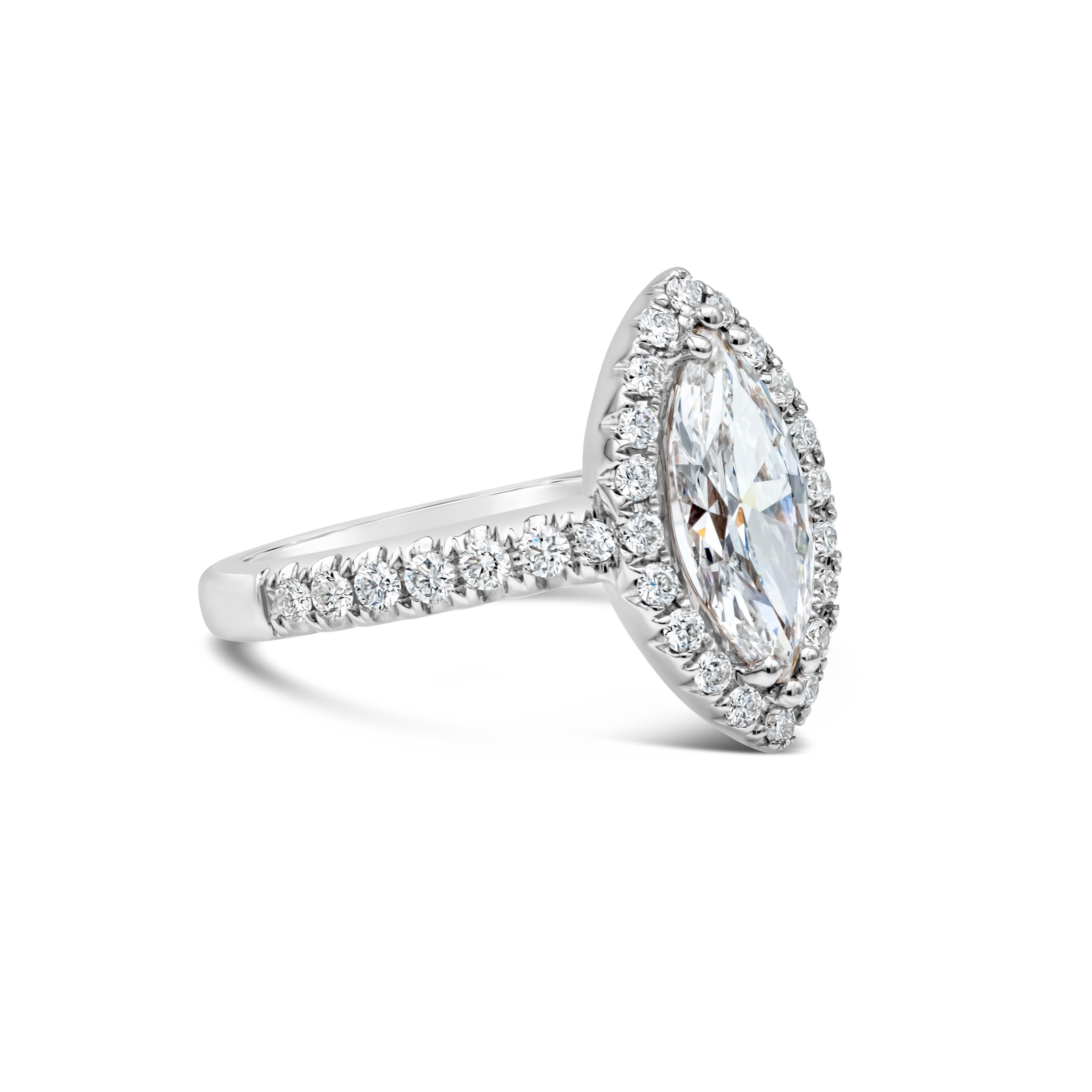 A unique engagement ring features a GIA Certified 1.26 carat marquise cut diamond, E Color and SI2 in Clarity. Accenting the center stone is a single row of brilliant round diamonds in halo setting.  Shank made in 18K White Gold is encrusted with