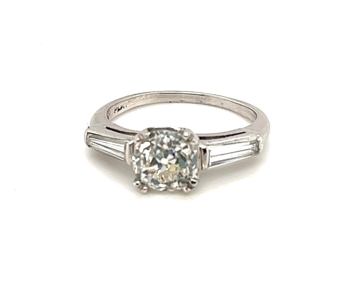 Offered here is a vintage diamond engagement ring, circa 1920-40.
Centered one single natural earth mined diamond, weighing 1.27 carats, G.I.A. certified to be an original old mine brilliant K in color and VS2 in clarity.
Center diamond is flanked