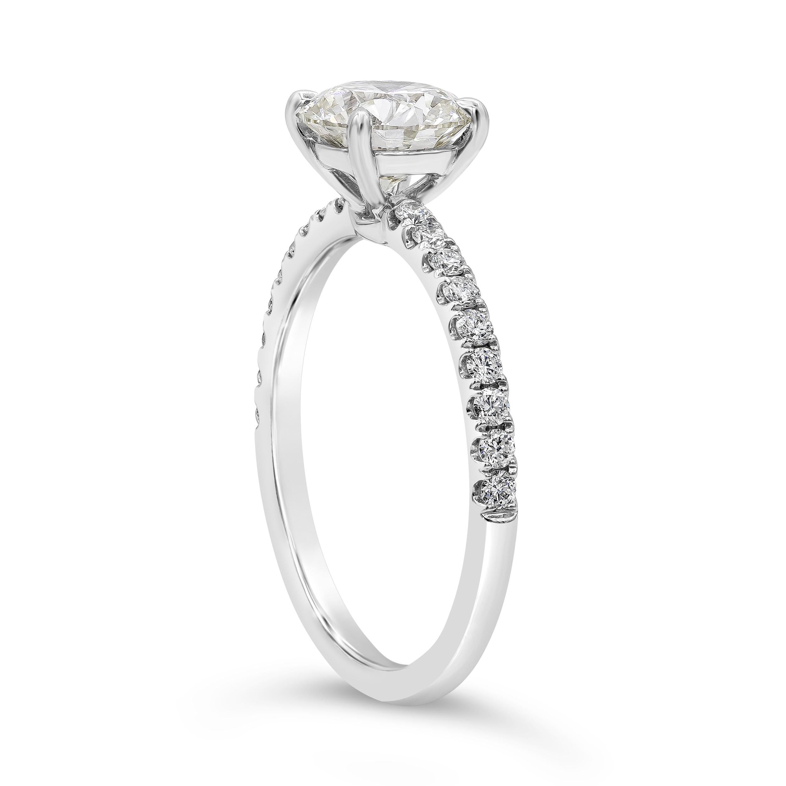 A classic engagement ring style showcasing a GIA Certified 1.27 carat brilliant round diamond, L Color and VVS1 in Clarity. Accenting the center diamond are round melee diamonds pave set half-way down the band weighing 0.28 carats total, Made with
