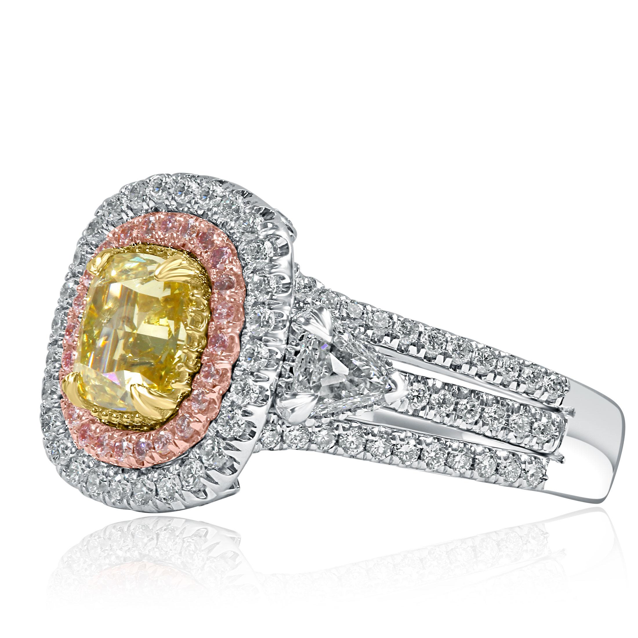 This stunning engagement ring showcases a breathtaking 1.27-carat GIA Certified cushion brilliant cut natural fancy vivid yellow diamond at its center. With its I2 clarity, this vibrant yellow diamond is a rare treasure, surrounded by a mesmerizing