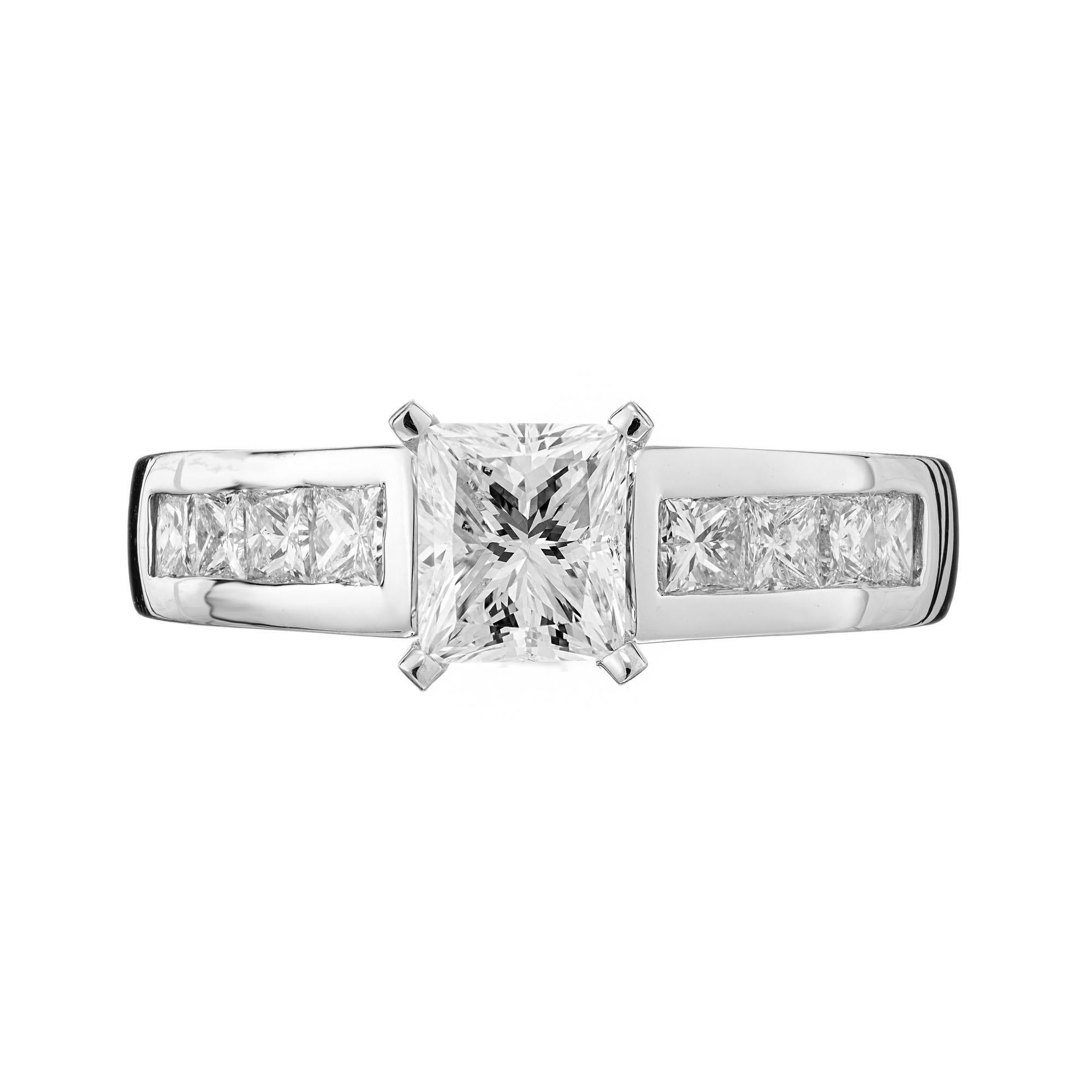 Diamond engagement ring. GIA certified princess cut center diamond in a 14k white gold setting with 8 channel set princess cut side diamonds.

1 princess cut diamond, E SI approx. .88cts GIA Certificate # 2211159543
8 princess cut diamonds, F-G SI