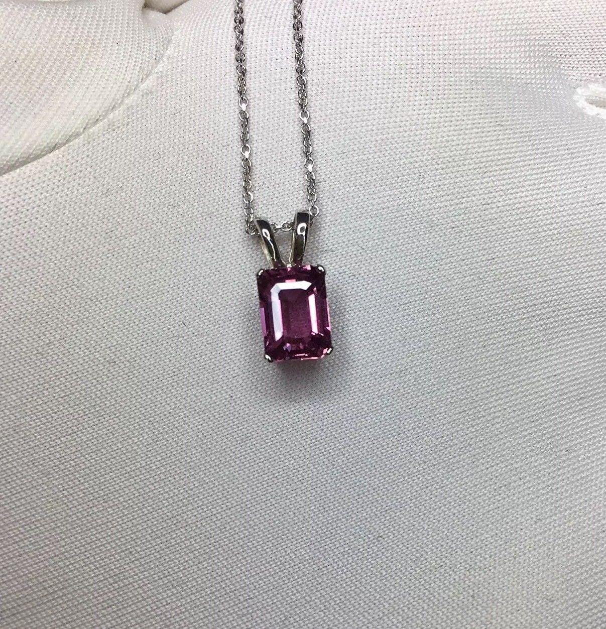 Natural vivid purplish pink sapphire solitaire pendant.

Beautiful emerald cut stone. Set in a fine 14k white gold pendant setting.

It has an excellent emerald cut with vivid colour and superb clarity. Very clean. 
Fully certified by GIA confirming