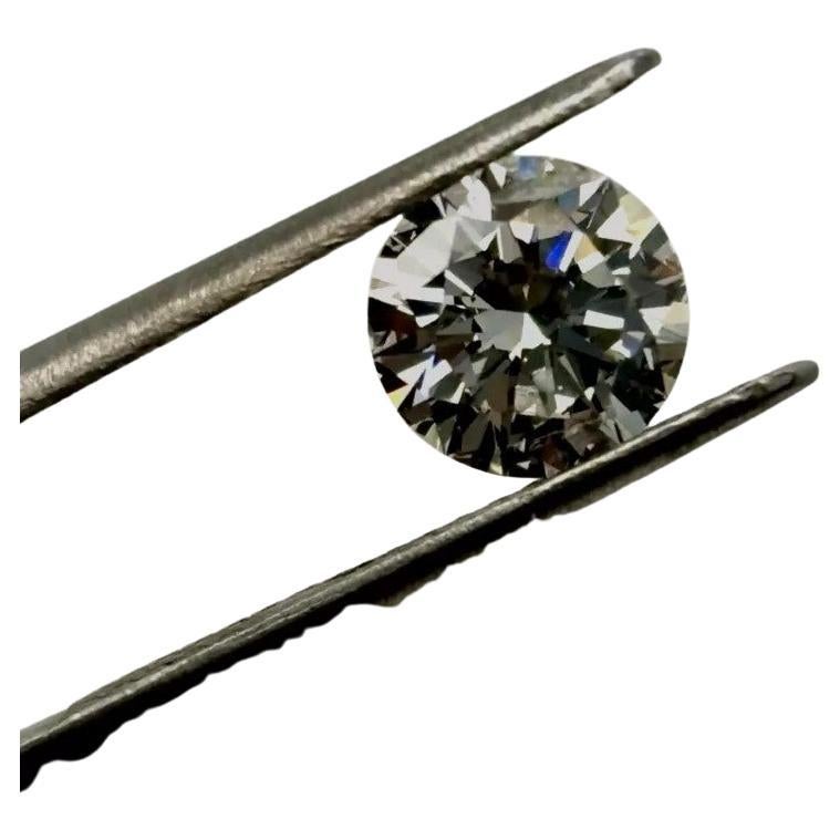 This is a GIA-certified 1.28 carat round brilliant cut natural diamond with Excellent Cut, Very Good Polish, and Very Good Symmetry—a rare combination that results in maximum sparkle and fire. Despite its I2 clarity grade, this diamond faces up