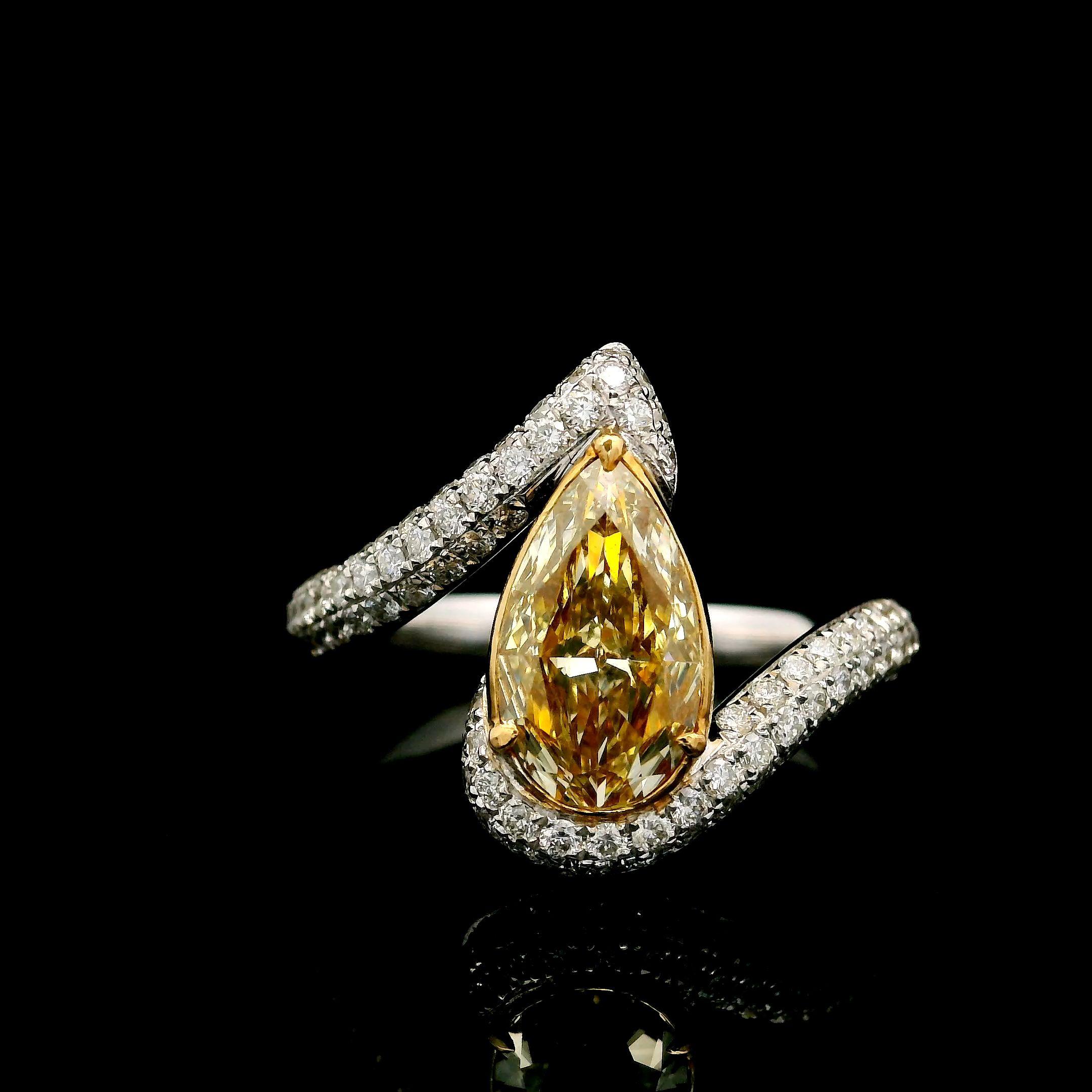 18kt white gold ring with diamonds

  Gold colour & karat: White gold 18kt
  Weight: 4.54 grams
  
  Set with-
  Stone type: Diamonds
  Shape: Pear
  Carat: 1.29 ct
  Colour: Fancy Light Brownish Yellow
  Clarity: VVS2
  
  Surrounding Stones: