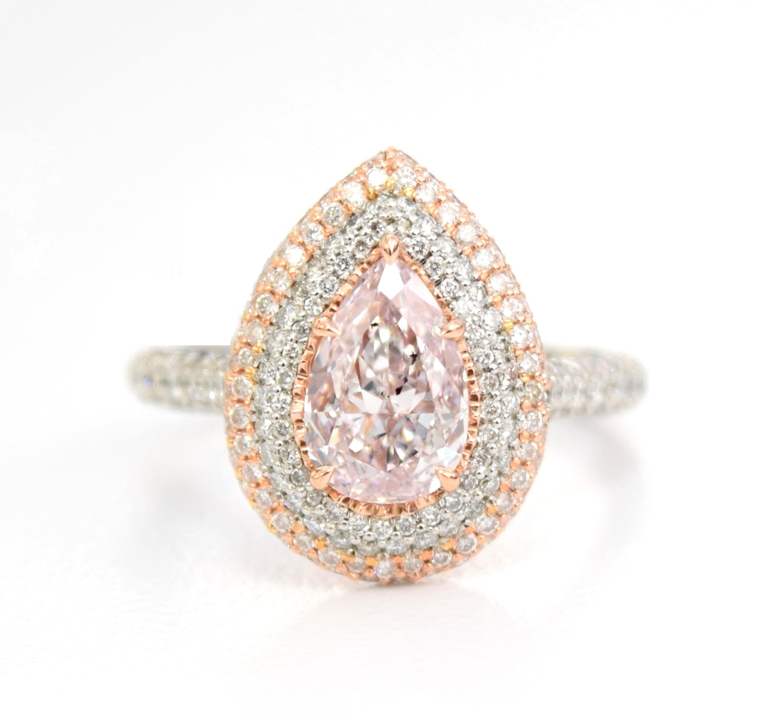 Platinum and 18k white gold engagement ring featuring a GIA graded 1.29ct natural fancy light purplish pink pear shape diamond with a clarity grade of Si2. 
The center diamond is surrounded by 240 round brilliant cut white diamonds weighing 1.21