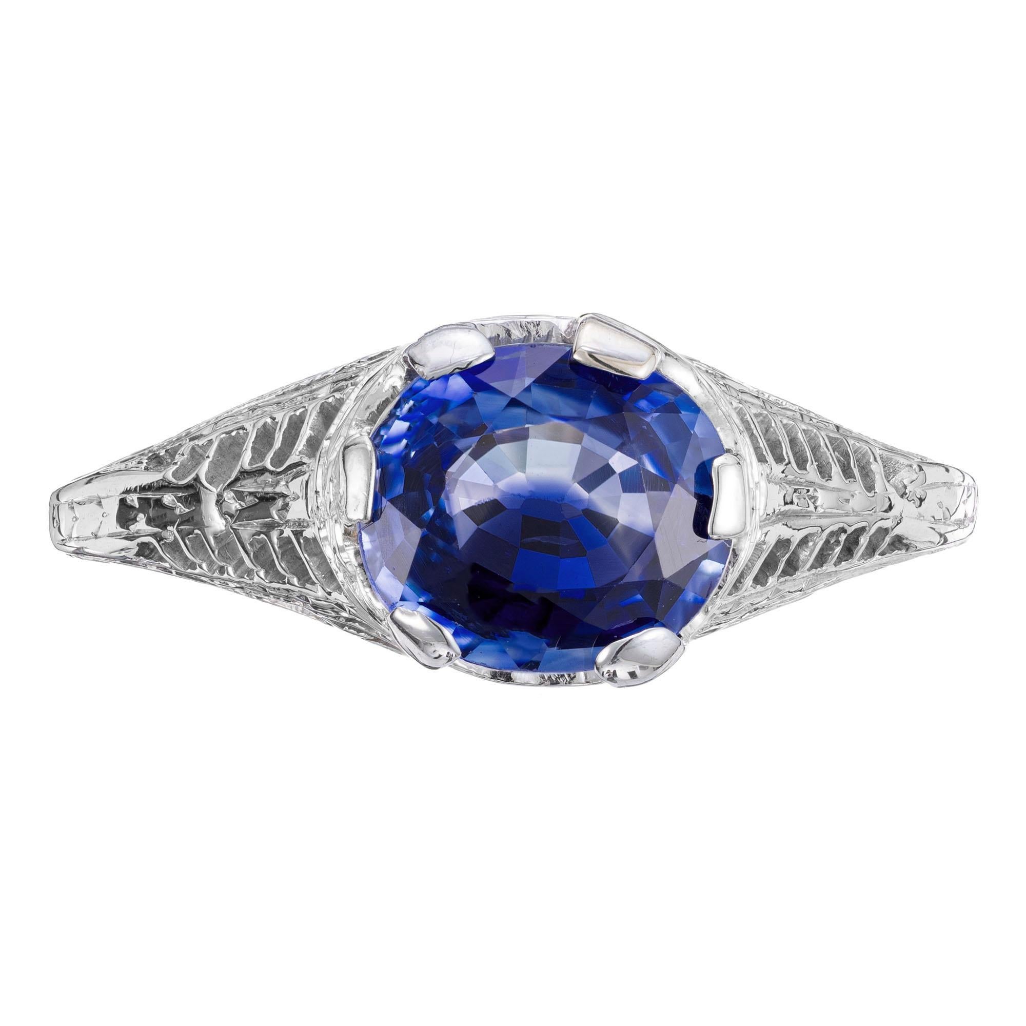 1930's oval sapphire engagement ring. GIA certified oval, side mounted rich deep blue sapphire in a  14k white gold filigree Art Deco setting. The Sapphire is 1.29ct, natural color, simple heat only. The GIA certified this as natural with only