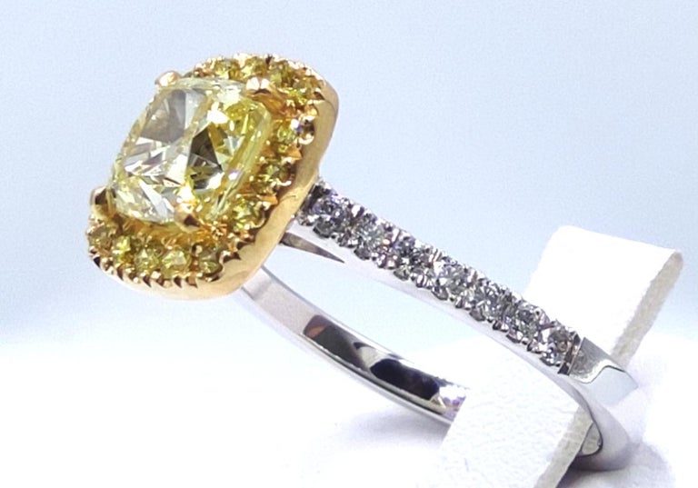 Beautiful and classic ring handmade in Italy, in 18K white and yellow gold.

The ring features a 1.30 carat GIA certified cushion diamond, which according to its gemological report, is graduated fancy light yellow in color and VS2 in clarity.

The