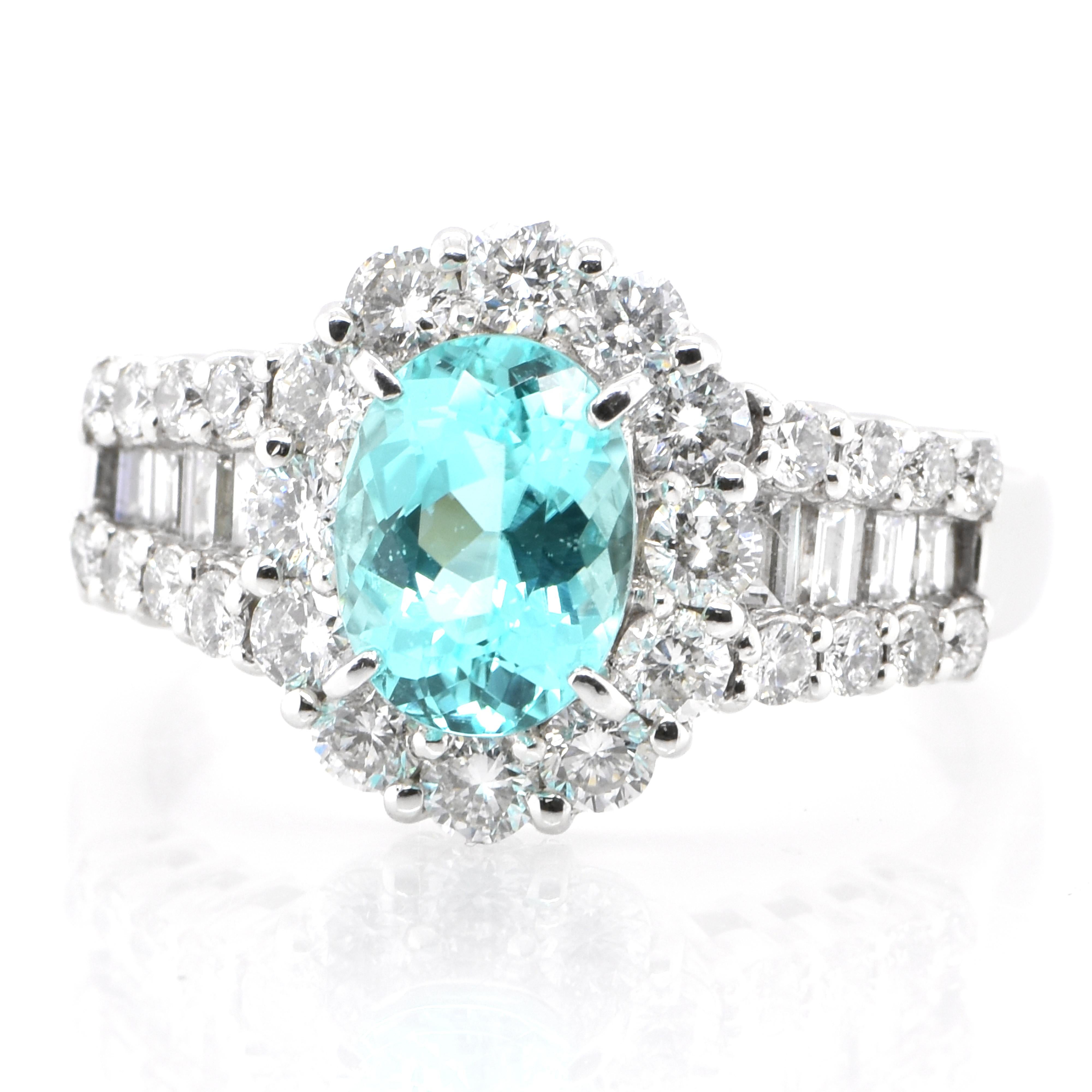 A beautiful ring featuring a GIA Certified 1.30 Carat Natural Mozambique Paraiba Tourmaline and 1.14 Carats of Diamond Accents set in Platinum. Paraiba Tourmalines were only discovered 30 years ago in the Brazilian state of the same name- Paraiba.