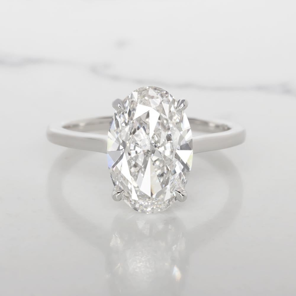 eye-catching 1.30ct GIA certified oval cut diamond has excellent E color, a completely eye clean appearance, and gorgeous, lively brilliance! 

The shape and cut of this diamond is absolutely ideal with gracefully curved shoulders and phenomenal