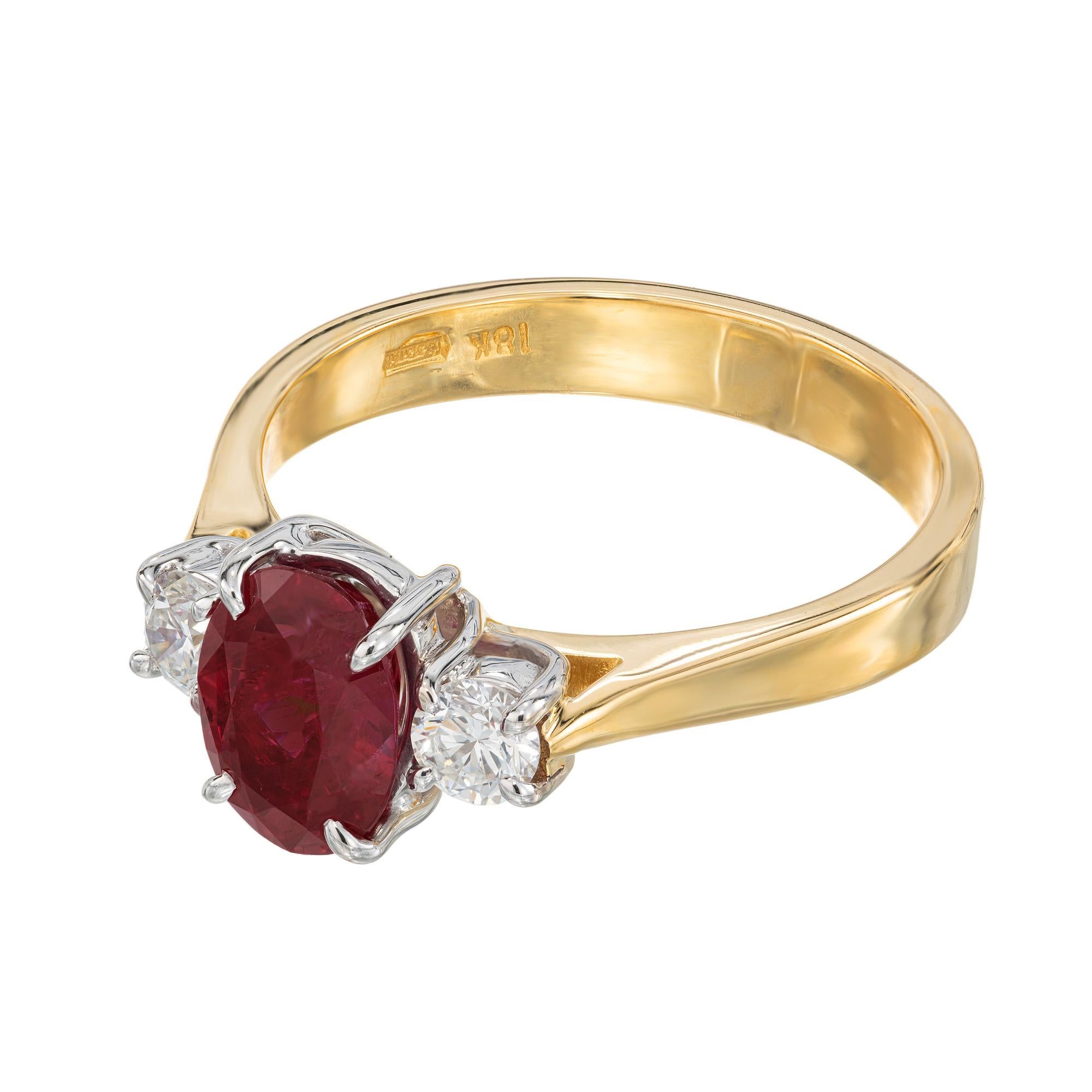 GIA Certified 1.30 Carat Ruby Diamond Two Tone Gold Engagement Ring. This remarkable ring showcases a stunning 1.30 carat oval ruby gemstone, flanked by 2 dazzling round cut diamonds, all set in an elegant two-tone 14k yellow and white gold setting.