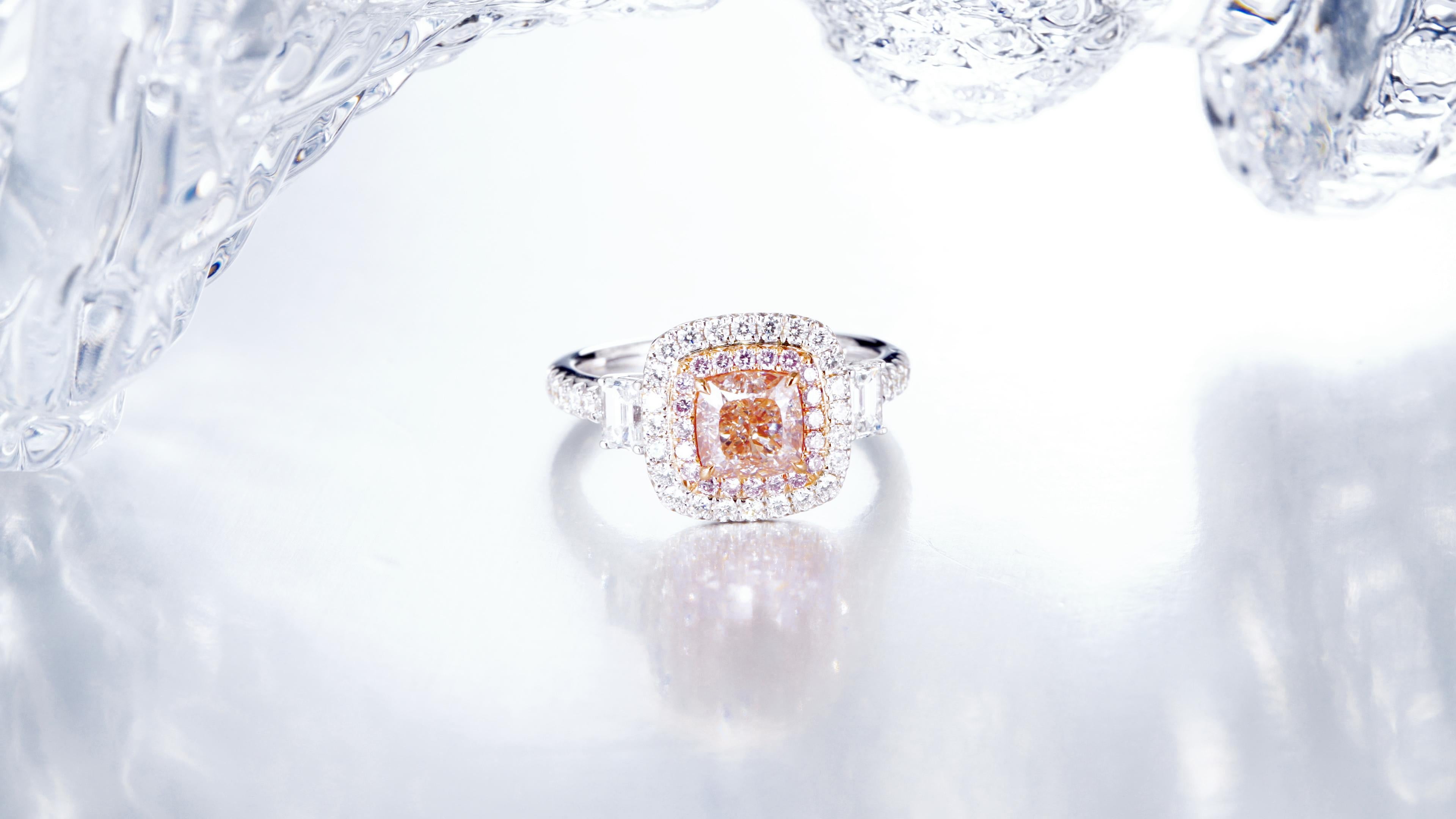 1.30-carat Natural Fancy Pink-Brown Cushion Diamond Ring set in luxurious 18kt gold. This exquisite piece boasts a captivating design, blending the warmth of brown hues with the delicate allure of fancy pink diamonds. Encircling the center stone is