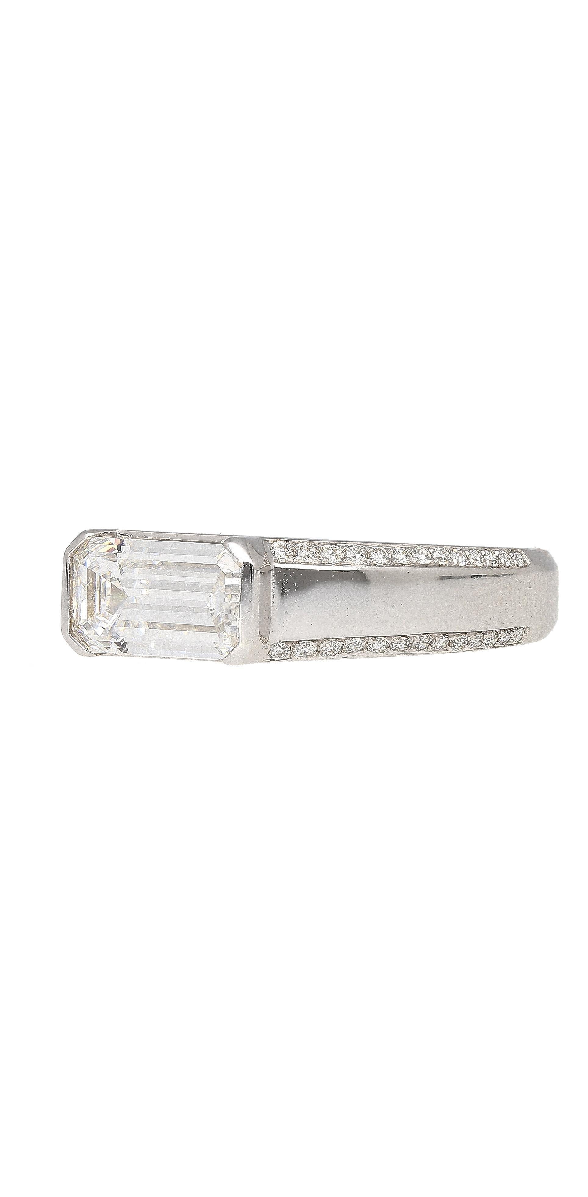 GIA Certified 1.33 Carat, Emerald Cut, D color, VVS2 clarity, Natural Diamond East West Set Band Ring in 18K white gold. Featuring 52 pave set round cut diamond side stones. 

This center stone diamond bears the best possible color grade in the