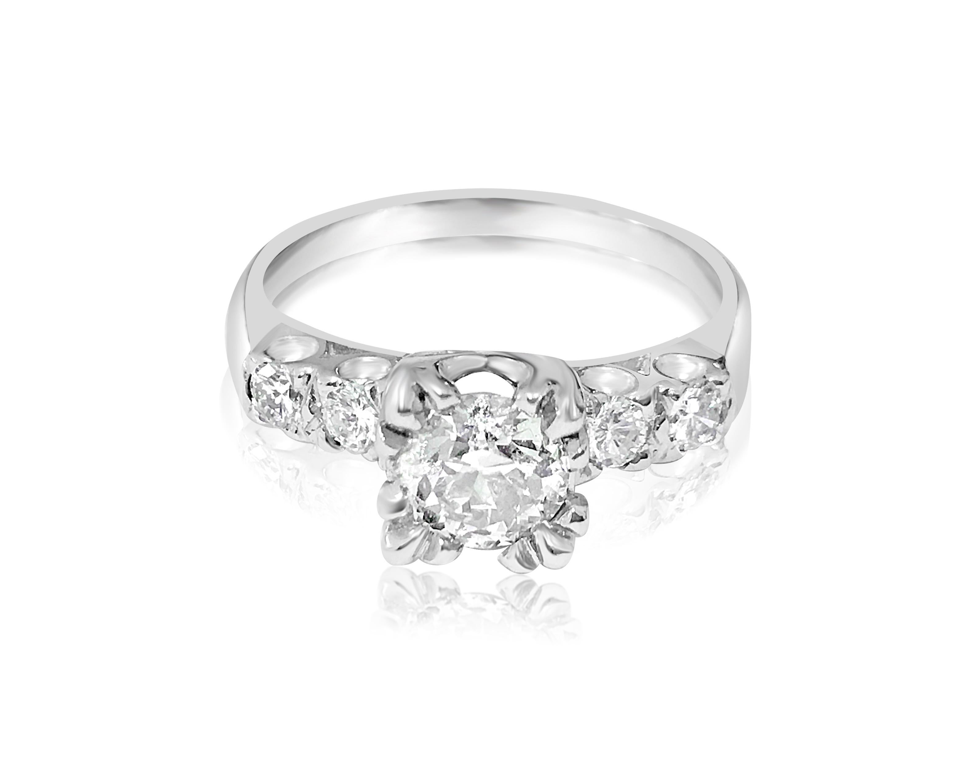 Metal: 14K White Gold.
1.00 carat center stone, G color and SI-1 Clarity. 
Side stones: 0.35 carat total. VS clarity and G color. 

Ring size: US 7.50
Free ring resizing available 

Excellent luster and shine. Beautiful art deco style engagement