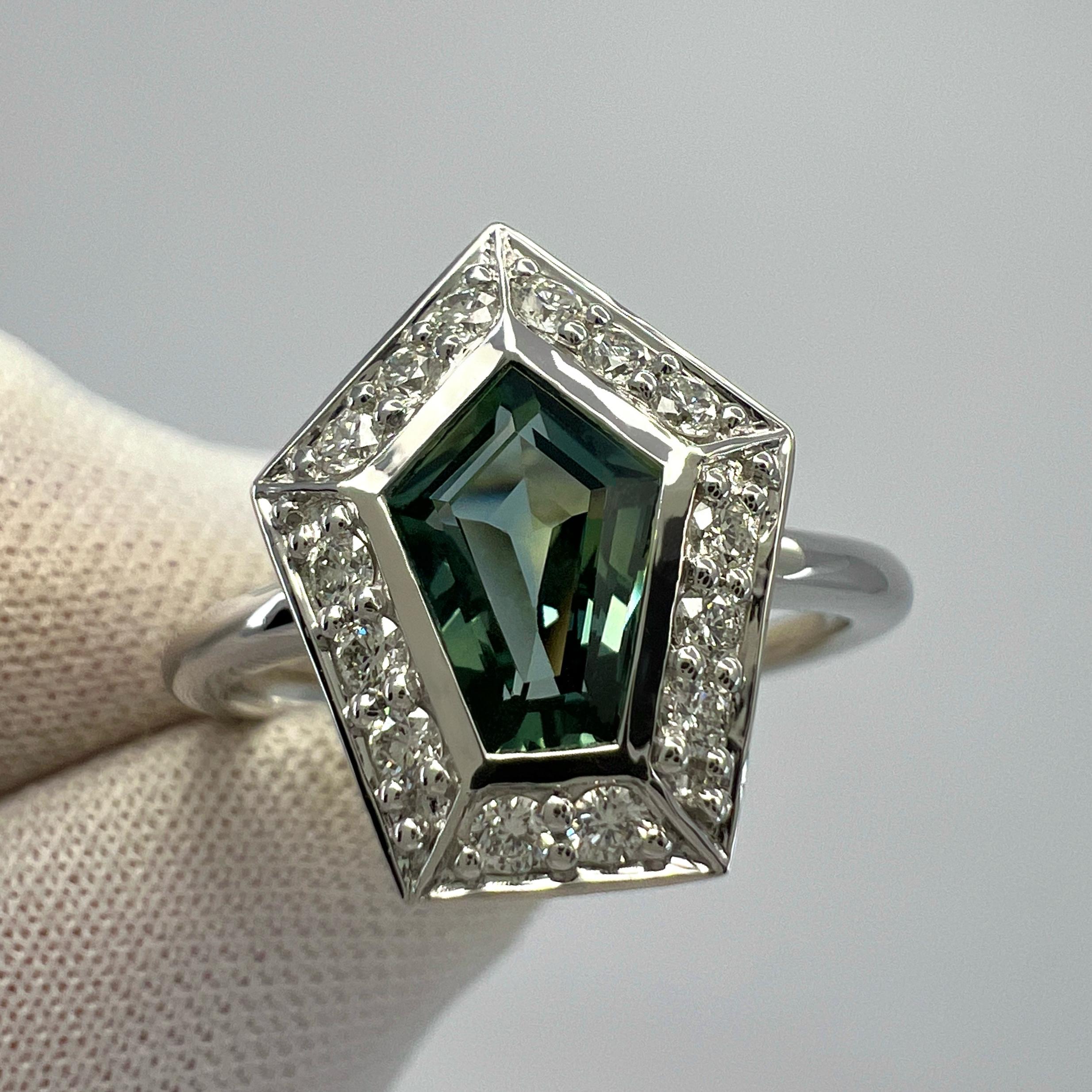 Unique Untreated Greenish Blue Fancy Kite Cut Sapphire And Diamond 18k White Gold Halo Ring. 1.35 Total Carat.

This fine ring features a beautiful 1.12 Carat centre sapphire with a unique greenish blue colour and an excellent fancy kite/pentagon