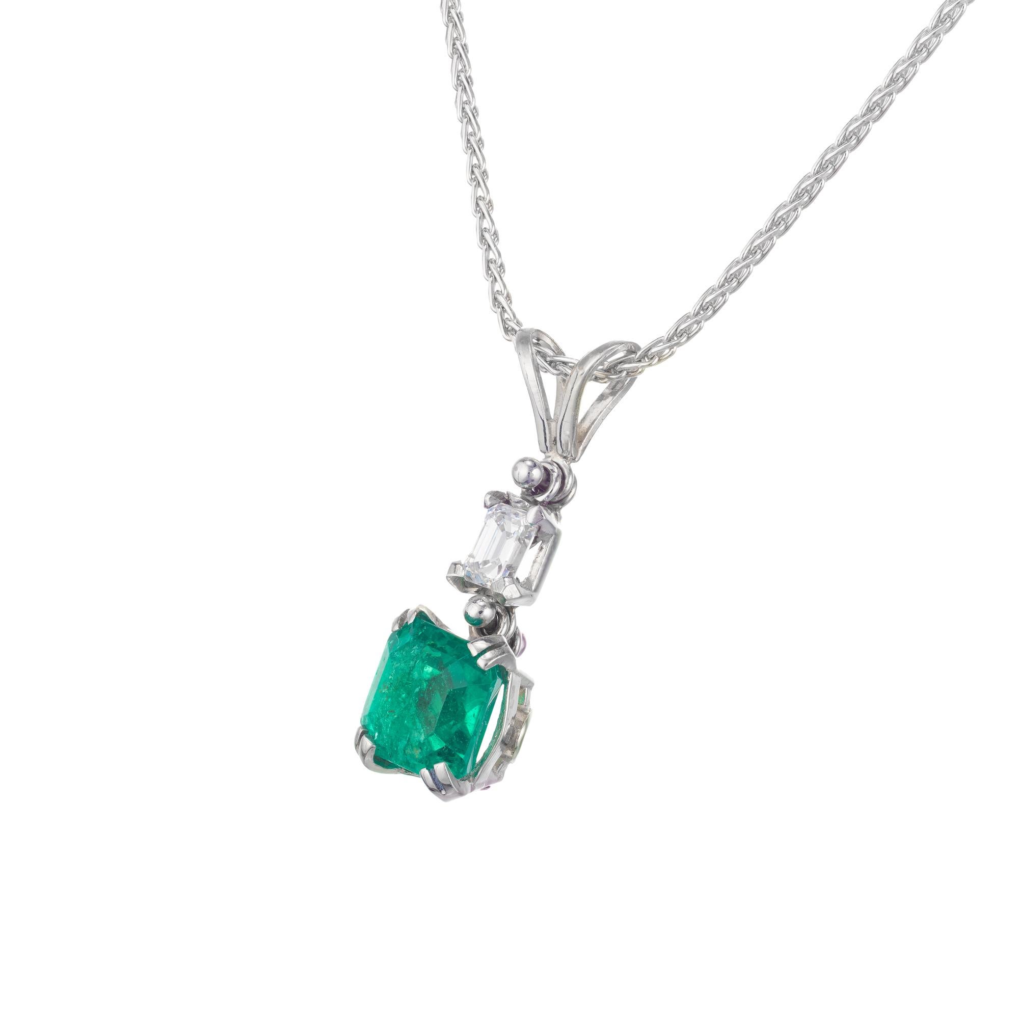 Handmade emerald and diamond platinum pendant necklace. circa 1940s. GIA Certified emerald of vibrant green color in a flexible drop pendant with an emerald cut diamond in a platinum setting and chain. 

1 octagonal cut green SI emerald, Approximate