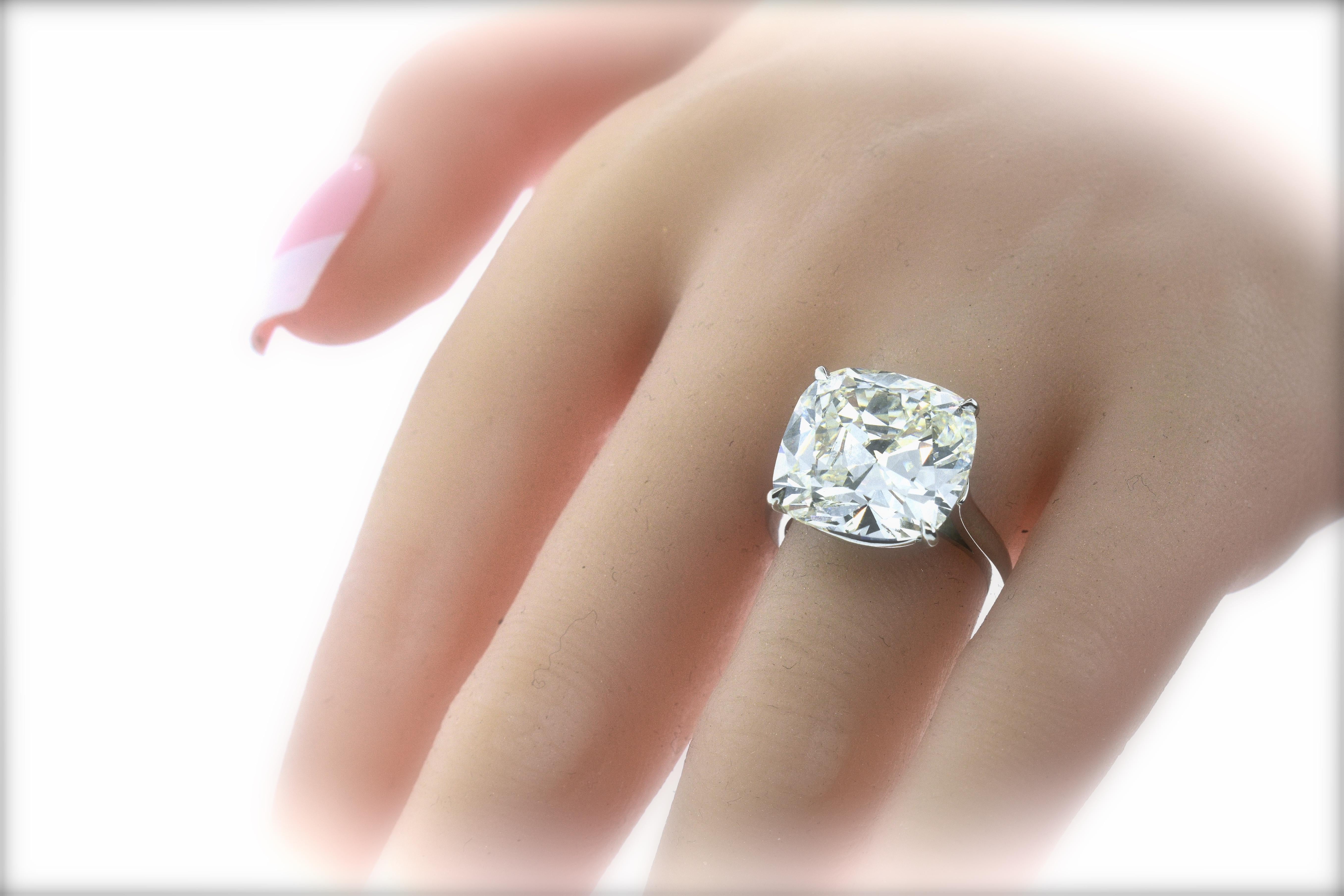 GIA certificate accompanies this old cushion cut diamond weighing exactly 13.70 cts., with a color grade of I (near colorless), and SI1, slightly included to the first degree.  Prong set in a hand made simple and classic platinum setting, this