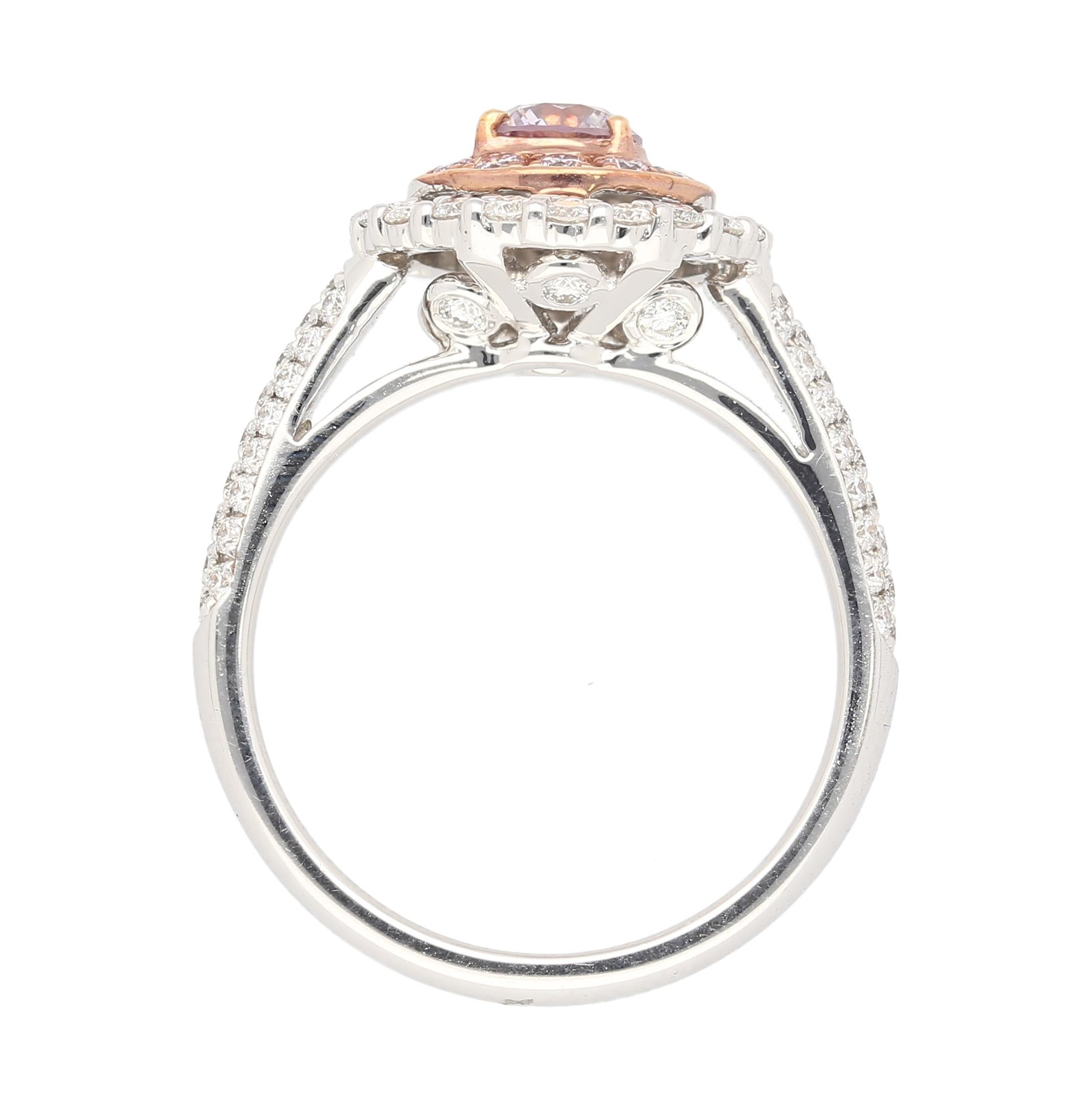 18K White and Rose Gold Ring, weighing 5.97 grams and boasting a size of 6.75. Centering an exquisite GIA Certified 0.48 carat round-brilliant diamond, displaying a rare and captivating Fancy Pink-Purple color.

The ring features a double diamond