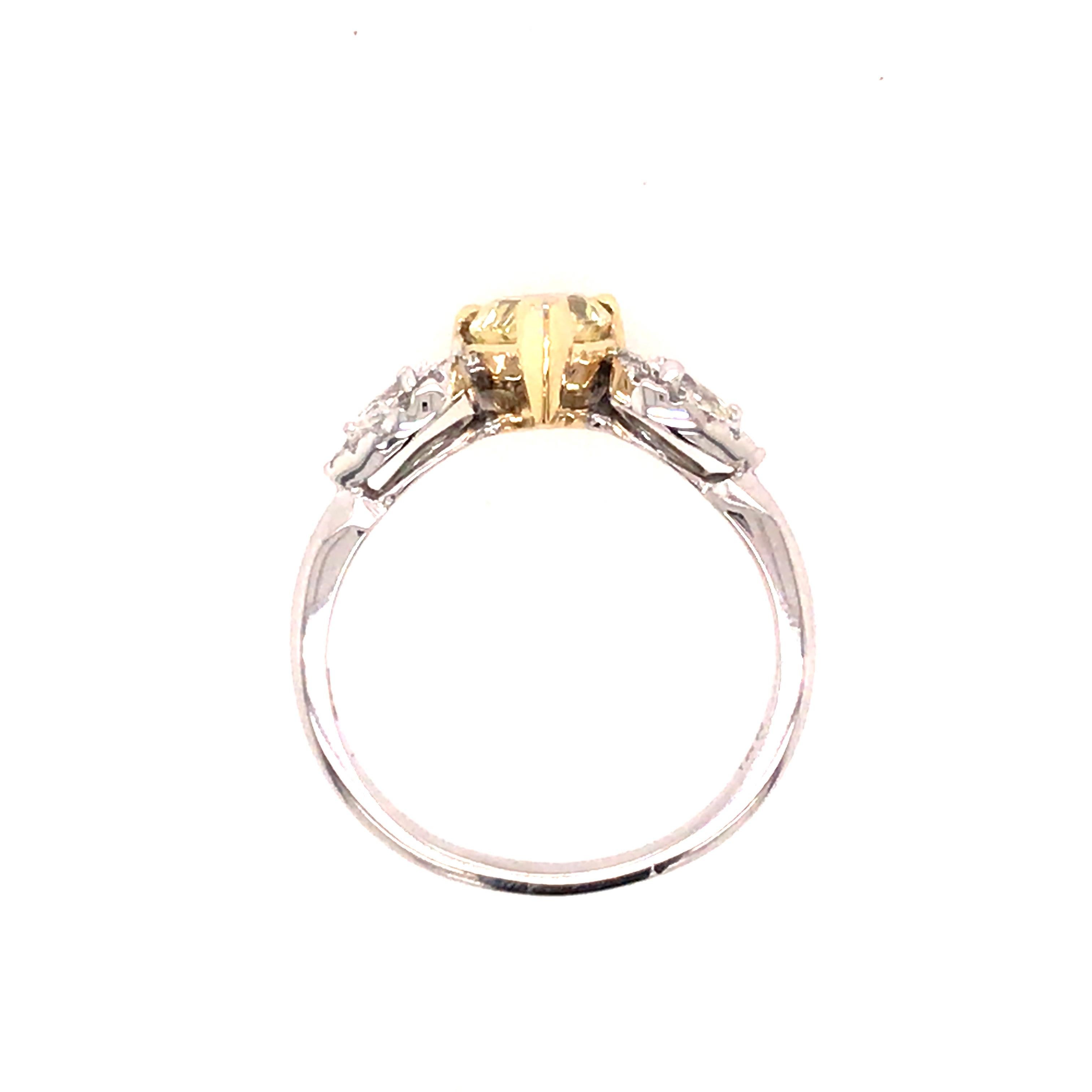 Women's GIA Certified 1.39 Carat Fancy Yellow Pear Shape Diamond 3-Stone Ring 18KTT For Sale