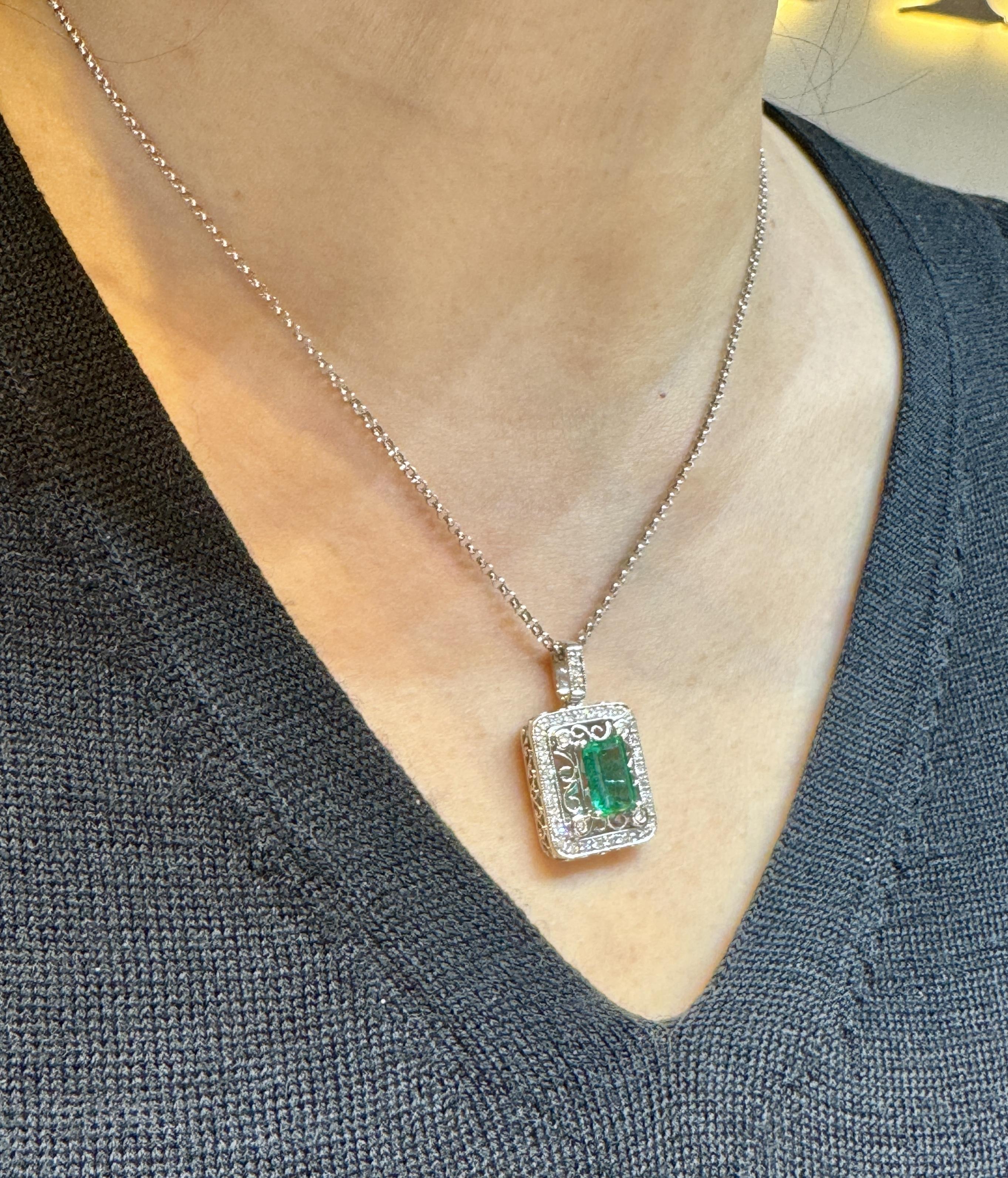 GIA Certified 1.39 Carat F2 Zambia Emerald Floating and Diamond Floral Pattern Pendant 18K Gold Necklace. 

Floating pendant necklace featuring a GIA certified Zambia origin 1.39 carat natural emerald center stone. Paired with 39 natural round-cut