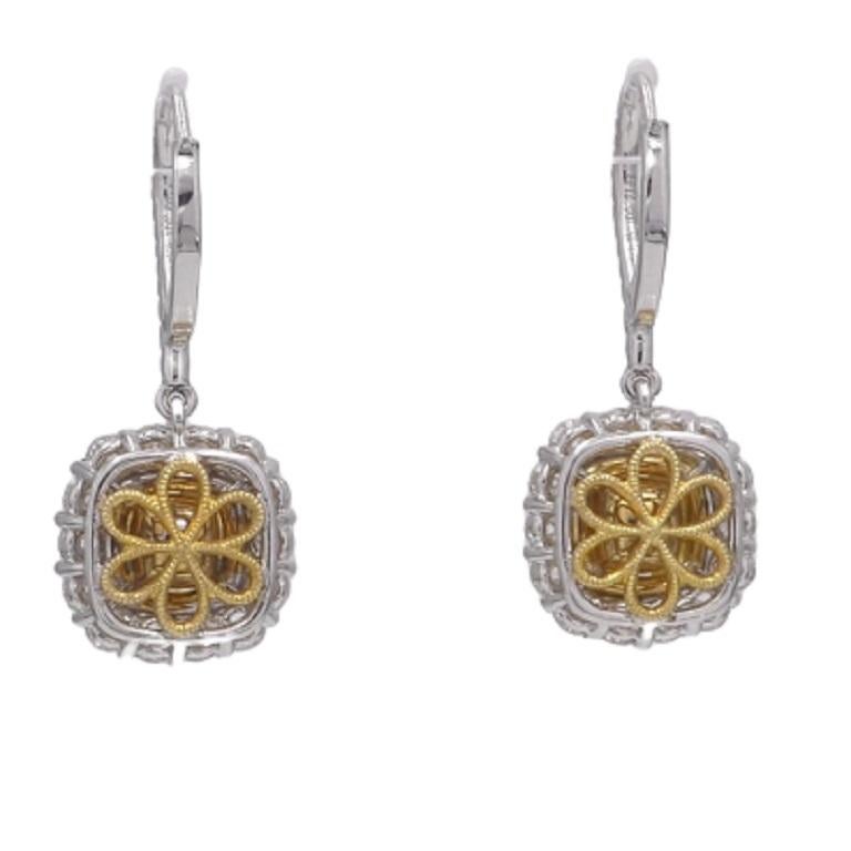 These earrings feature two GIA Certified Natural Fancy Yellow Cushion Cut centers, inside halos of round yellow and round white diamonds. The centers total 1.40 carats. The halo diamonds, as well as those decorating the front of the lever-back hoop,