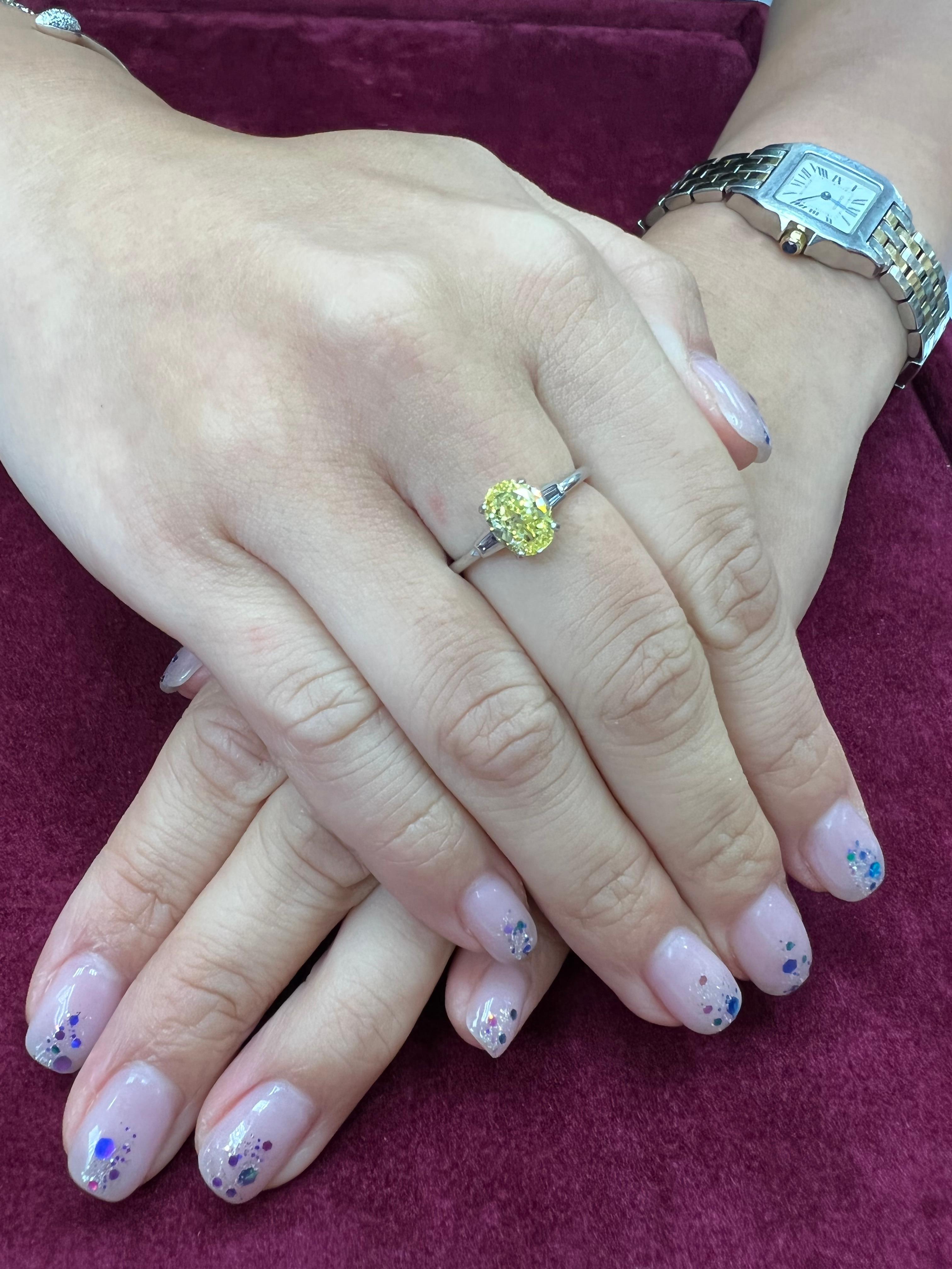 Please check out the HD video. Here is a classic colored diamond engagement ring. This dainty platinum  ring packs a punch with the best possible color grading of fancy vivid yellow by GIA. The color of this ring is very strong and therefore does