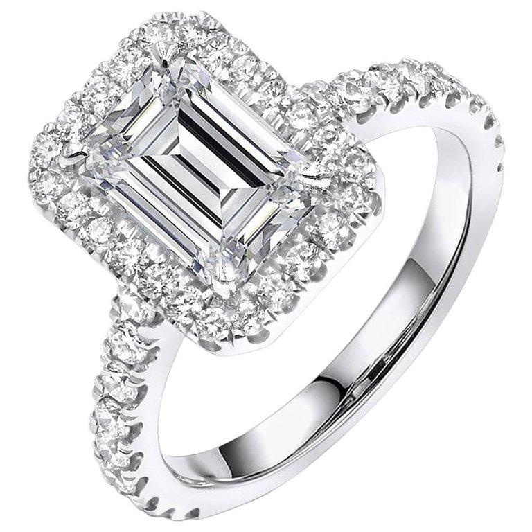 This beautiful Emerald cut diamond ring is set in 14k white gold.Center diamond 1.40ct Emerald cut diamond. VVS2 clarity J color. GIA certified.The halo and the sides contain 0.89ct round brilliant cut diamonds VS2 clarity G/H color.The ring is