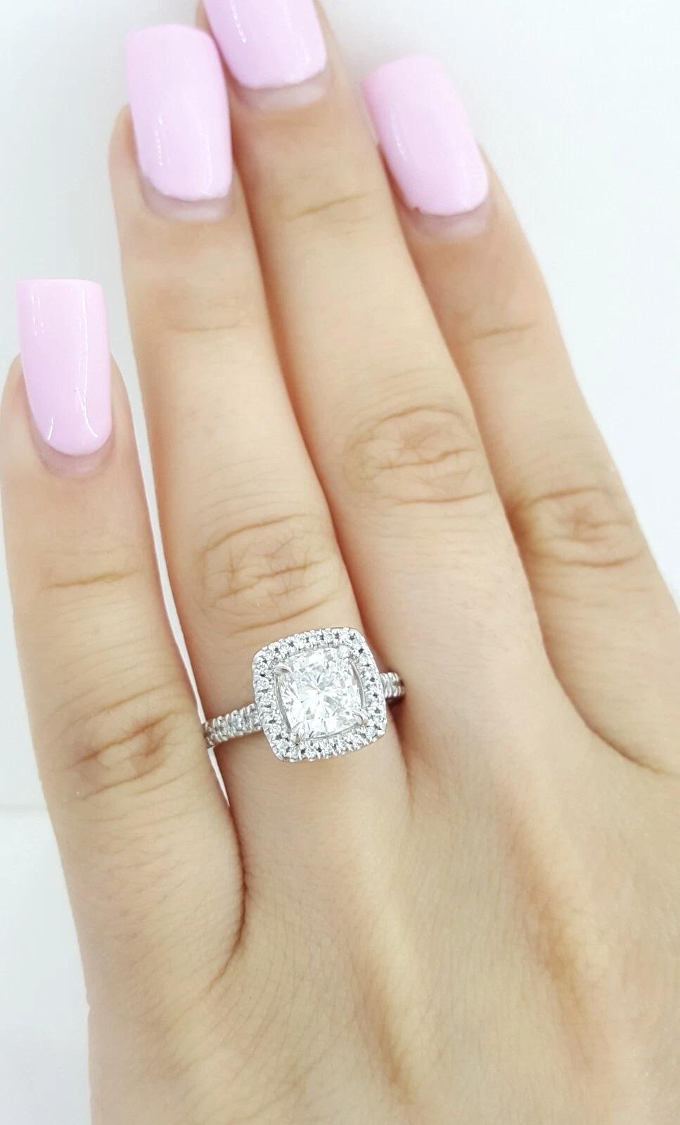 Crafted in timeless platinum, this exquisite engagement ring showcases a stunning 1.41 carat natural cushion brilliant cut diamond, GIA certified and laser-inscribed. The center stone is graded F color and VS2 clarity, with an Excellent Ideal Cut