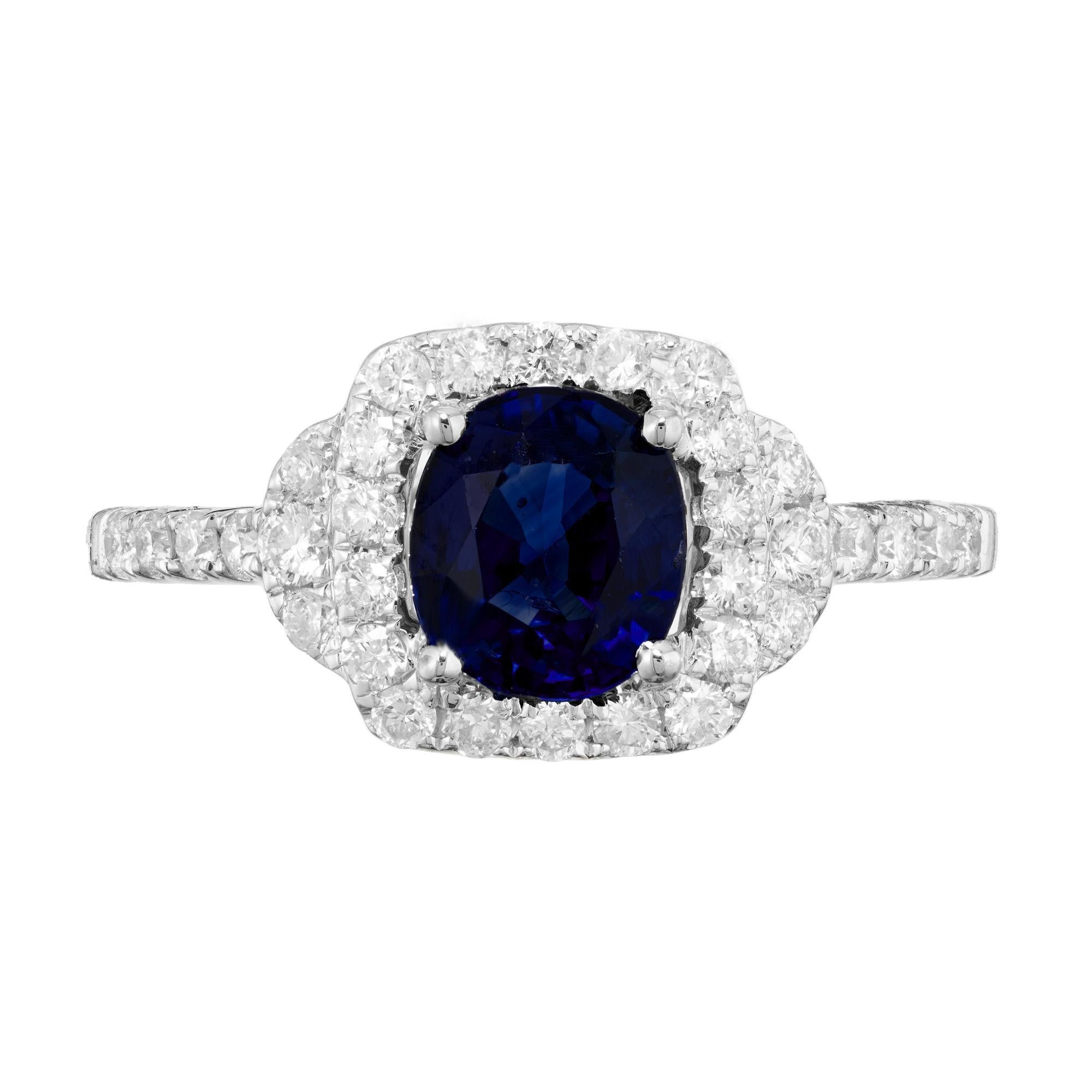 Bright, crisp, pure blue cushion cut Sapphire and diamond halo engagement ring. 1.41ct blue sapphire center stone. Mounted in a 18k white gold setting with a halo of round full cut diamonds. Accented with diamonds along the both shoulders of the