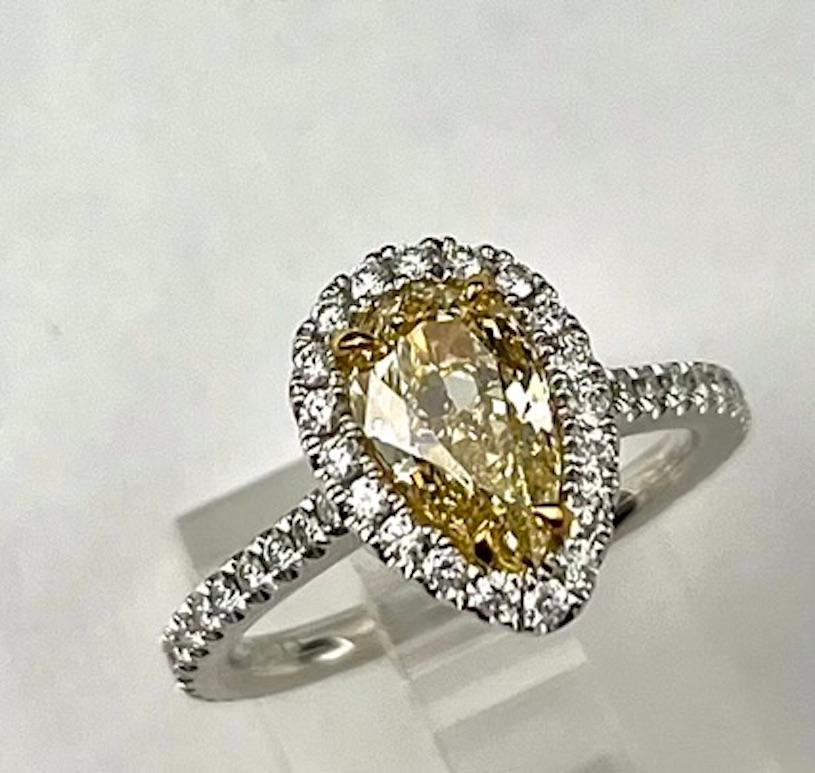 This is a simple and elegant ring featuring a 1.41Ct beautifully cut Pear Shape Natural Fancy Yellow Diamond that is also extremely clean at being a VS1 clarity. The saturation of the color is deep making the color appear closer to Fancy Intense,