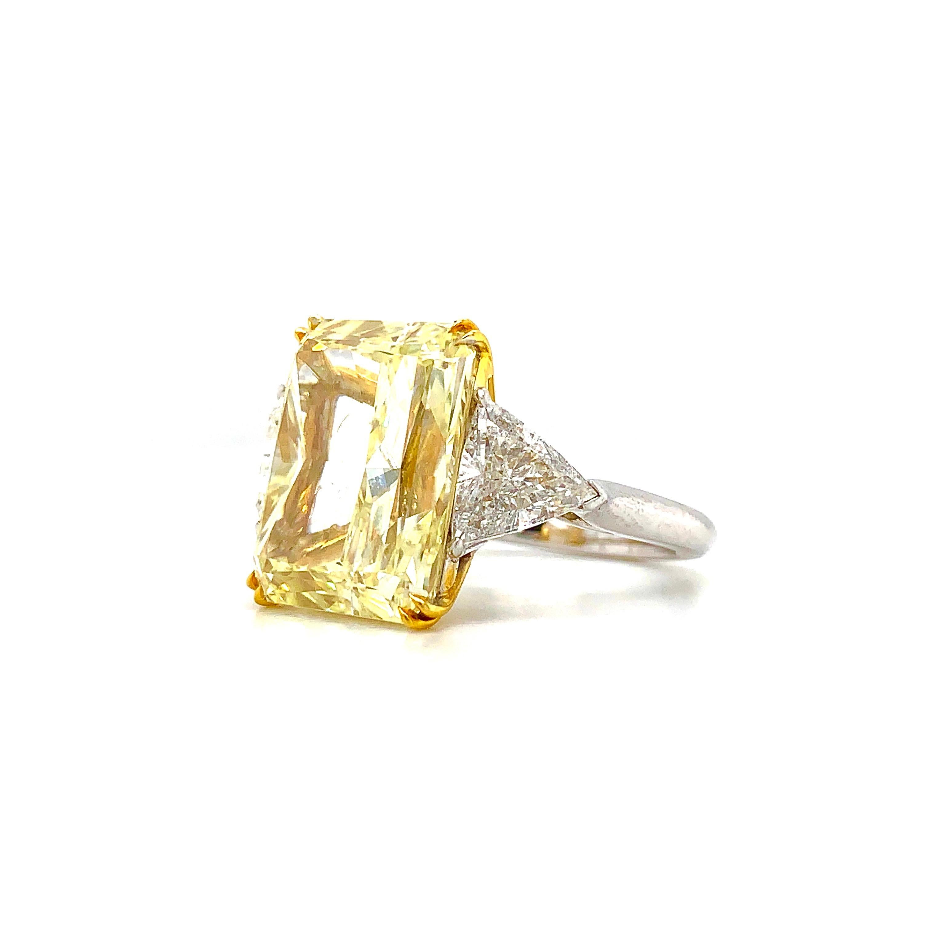 This magnificent engagement ring features a 14.20 carat yellow rectangular radiant cut diamond . this diamond exhibits strong canary yellow color with full saturation. this diamond is graded by the GIA as being natural in color. this stone is set in