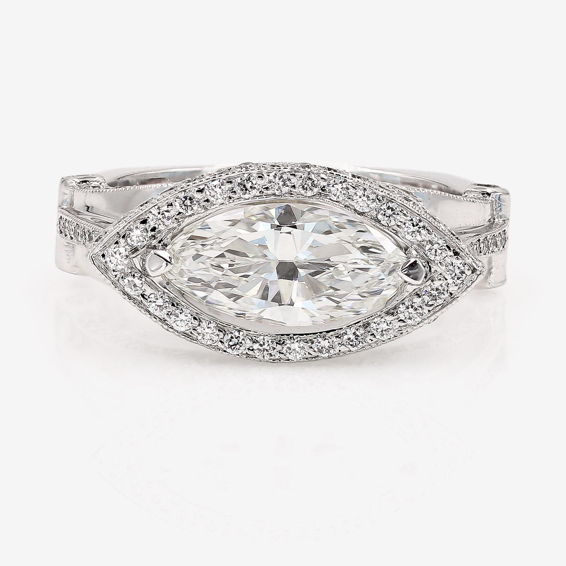 This Lester Lampert original setting in 18kt. white gold features a 1.42cts. marquise cut center that is H in color and VVS1 in clarity. The center is set sideways and is surrounded by 138 ideal cut round diamonds=.85ct. t.w. The round diamonds are