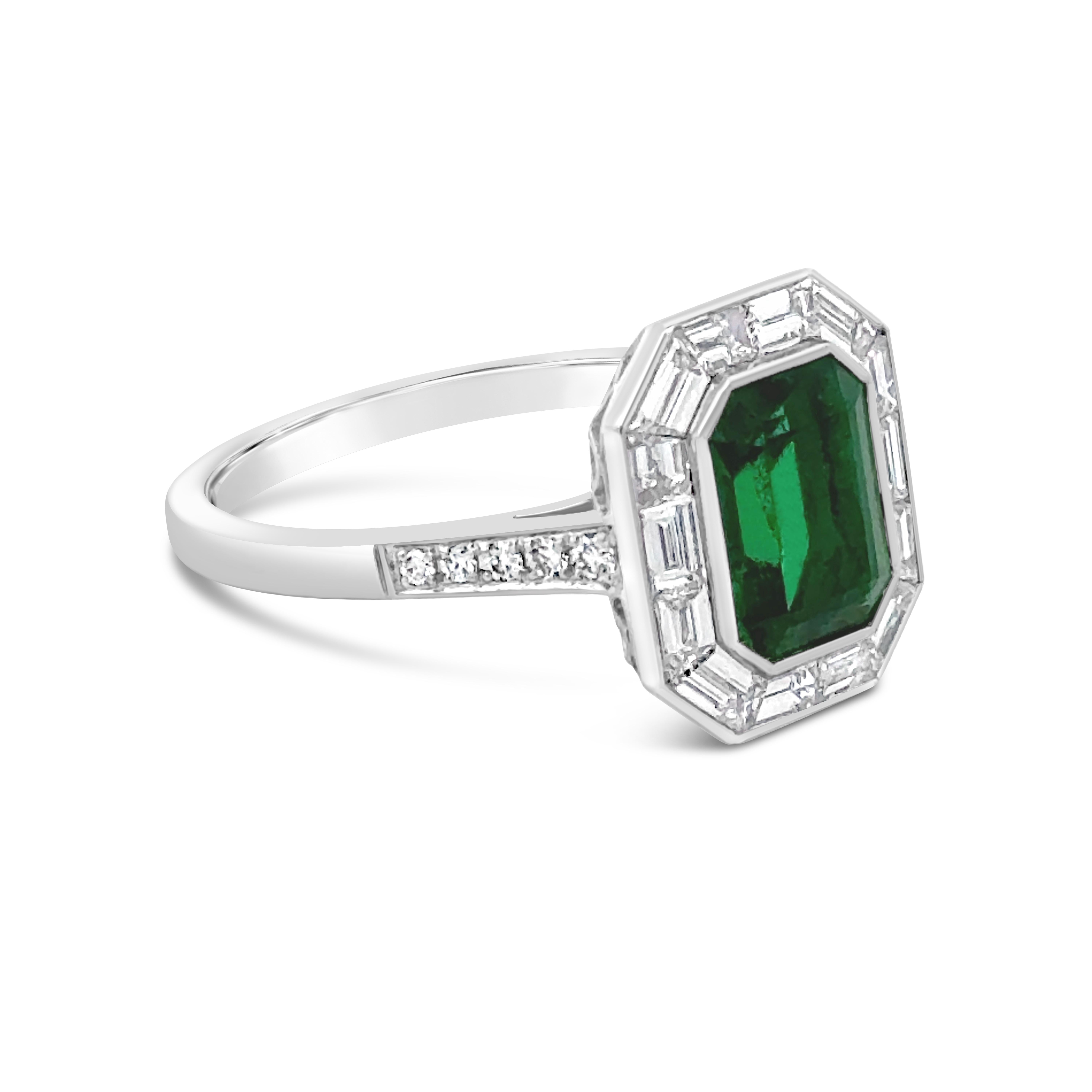 A precious engagement ring, featuring a GIA certified 1.43 carats emerald cut Zambian emerald, bezel-set in platinum. Surrounded by tapered baguette diamonds and accented by round cut diamonds on the shank in a half-eternity setting. Accent diamonds