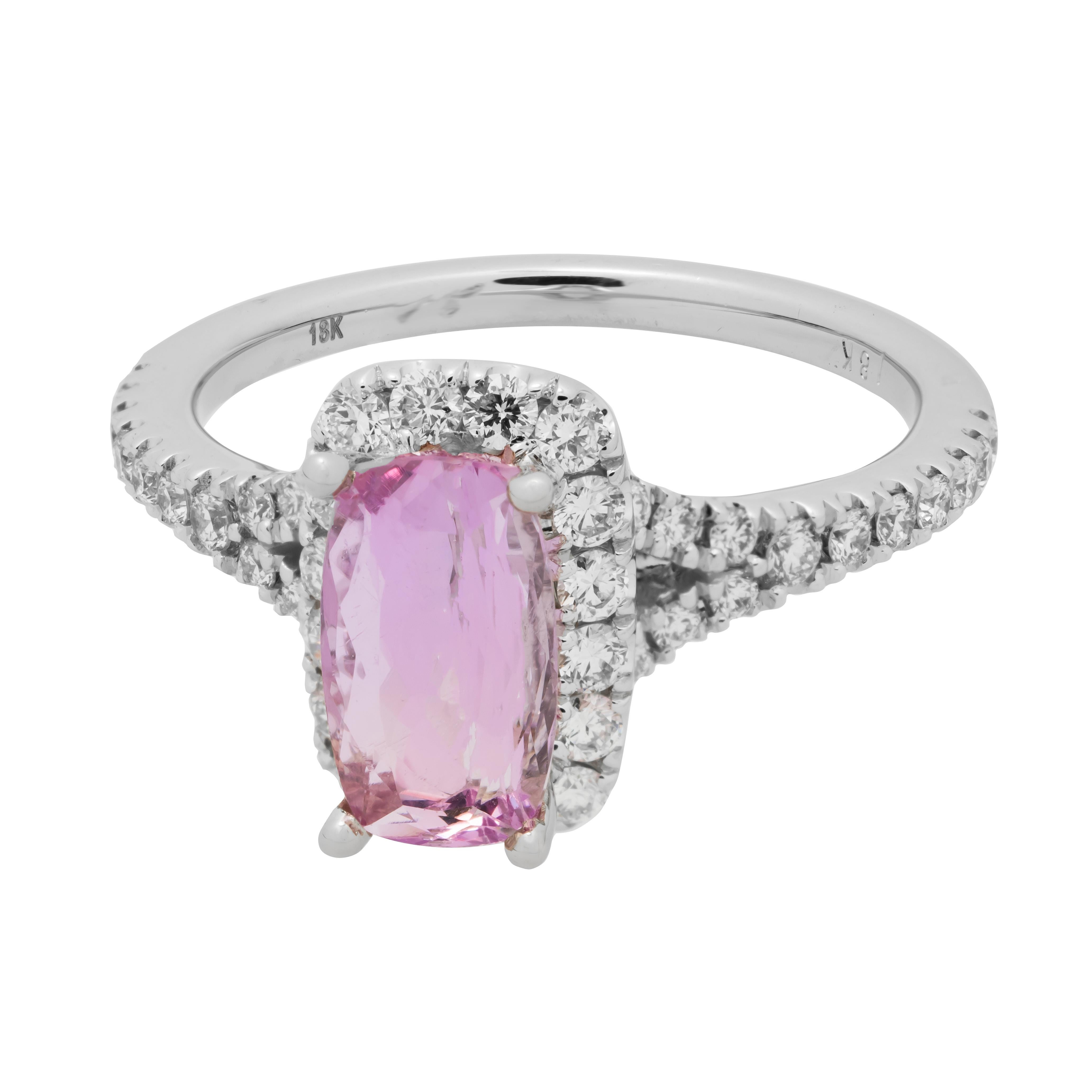 Bright 1.44 carat pink elongated cushion precious Topaz engagement ring with a micro Pavé diamond halo and shank in a white gold setting. The 18k white gold mounting is adorned with round full cut diamonds along both shoulders of the split shank