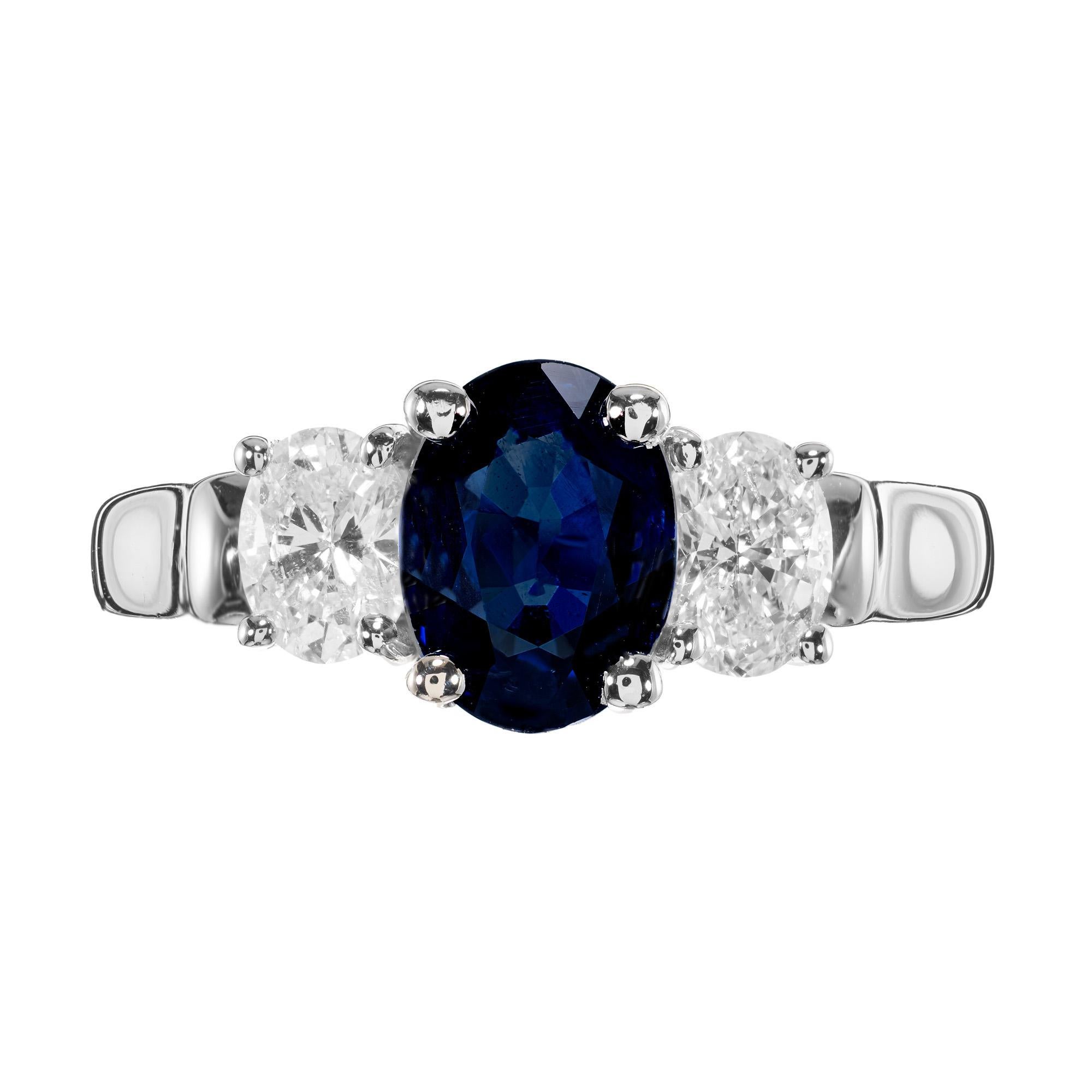 Beautiful sapphire and diamond engagement ring. Starting with a 1.45 carat GIA certified royal blue 1.45ct oval sapphire which is accented by 2 oval diamonds, set in a 14k white gold three-stone setting. The GIA has certified the sapphire as